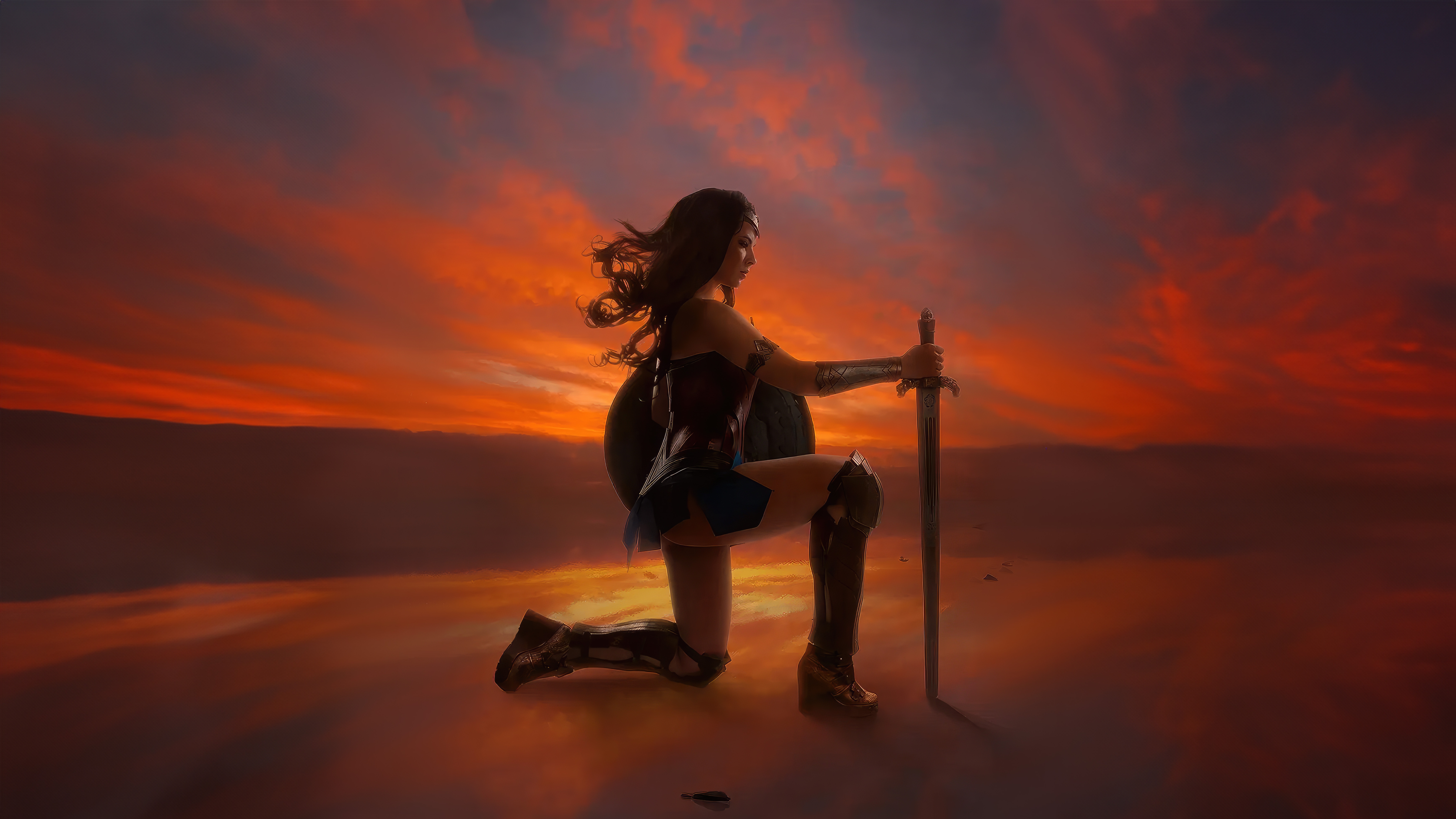 Wonder Woman kneeling with sword at sunset HD Wallpaper