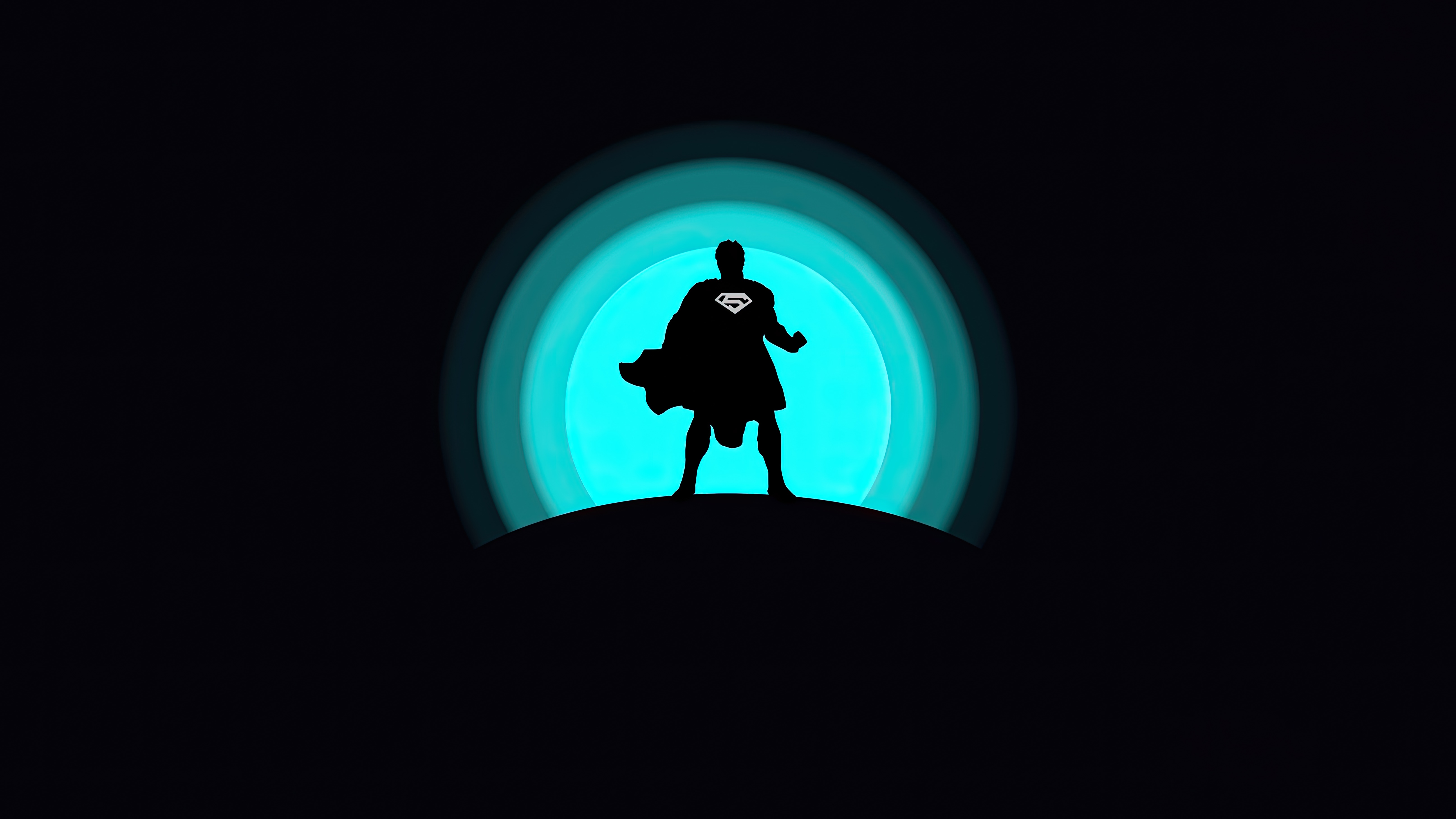 Superman Silhouette Against a Glowing Blue Circle HD Wallpaper