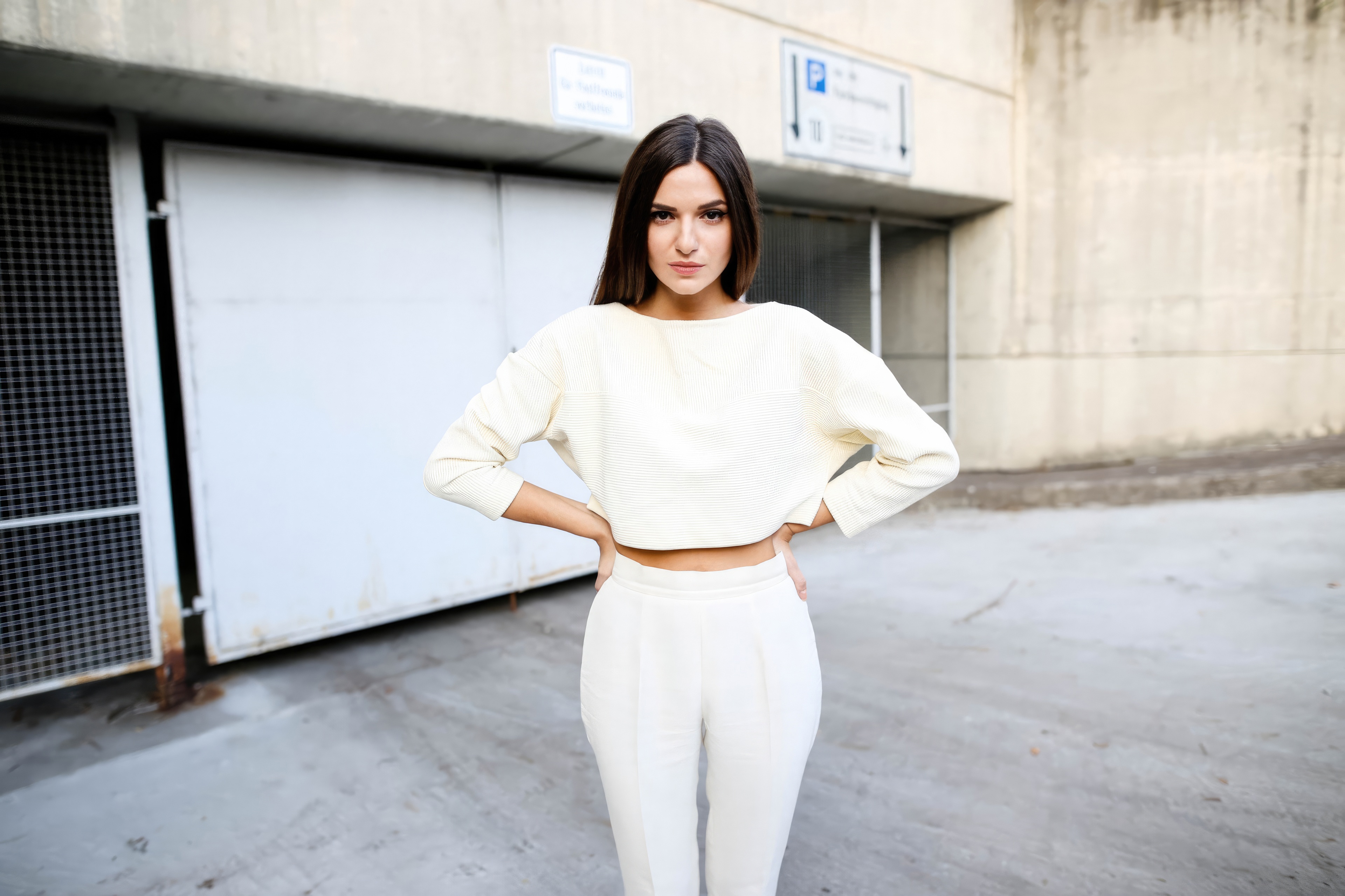 Woman in white outfit with hands on waist HD Wallpaper
