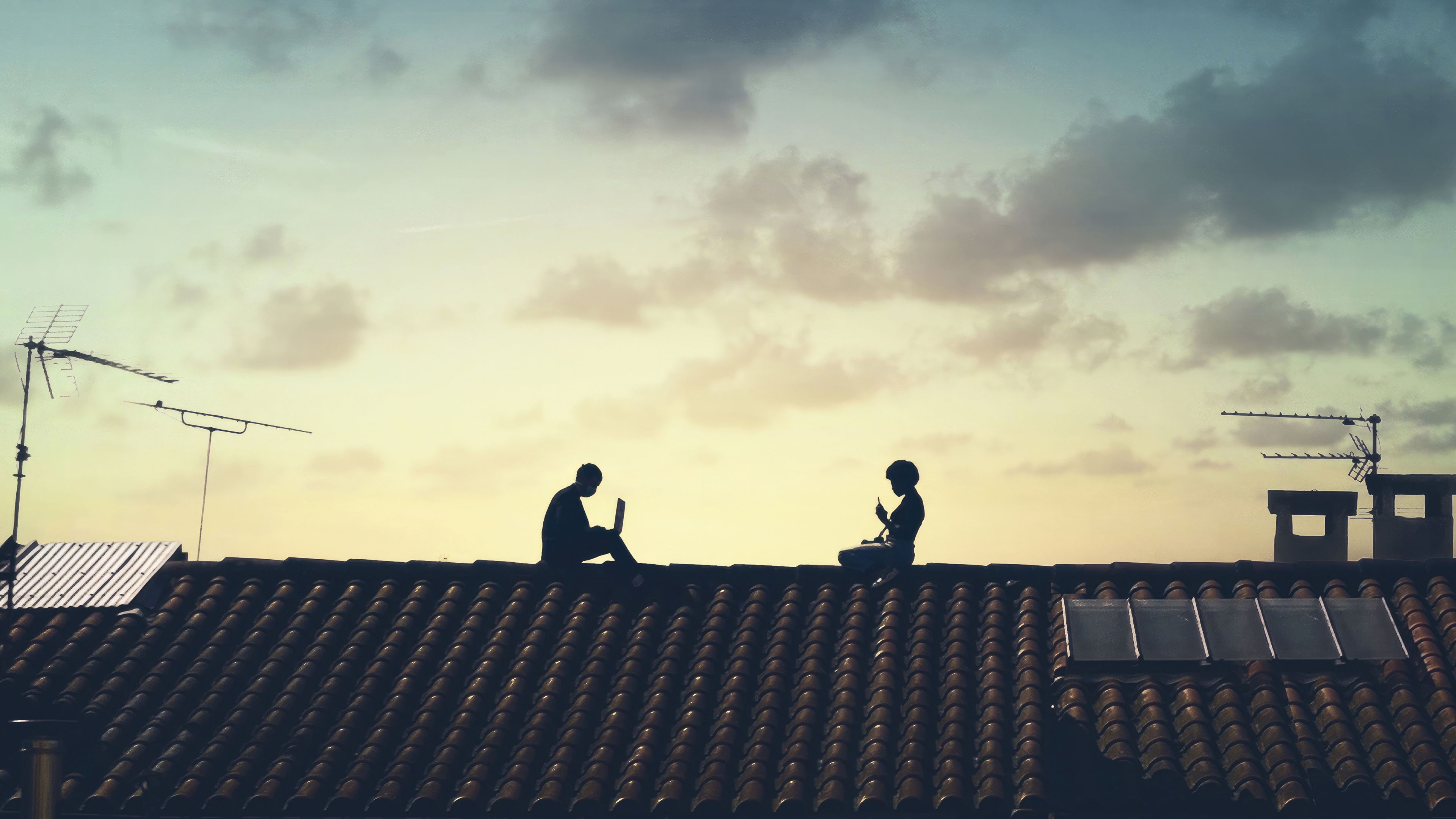 Two people on a rooftop with laptops HD Wallpaper