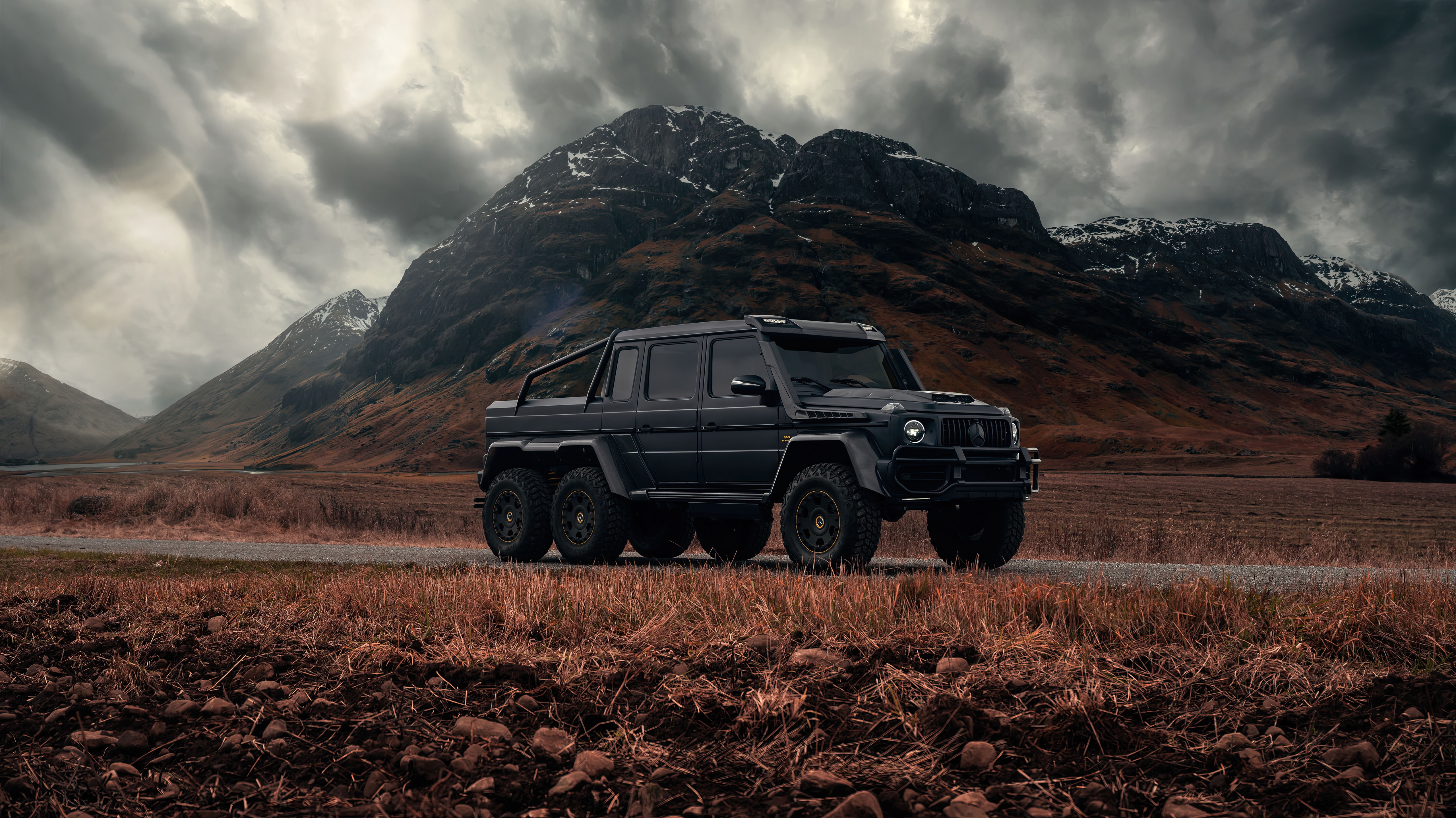 Black Mercedes-AMG G 63 6x6 on a road with mountains HD Wallpaper