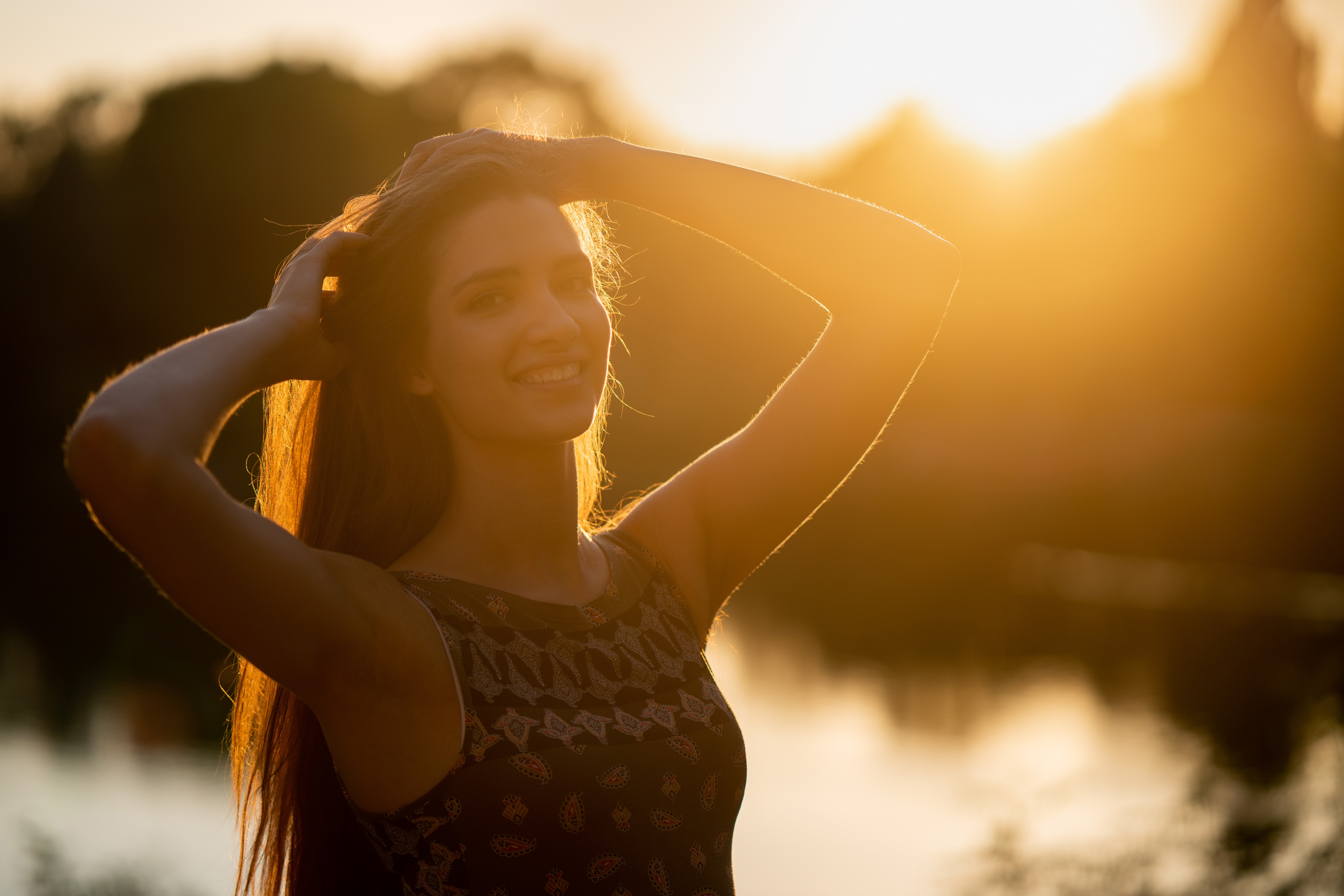 Young woman smiling during golden hour HD Wallpaper
