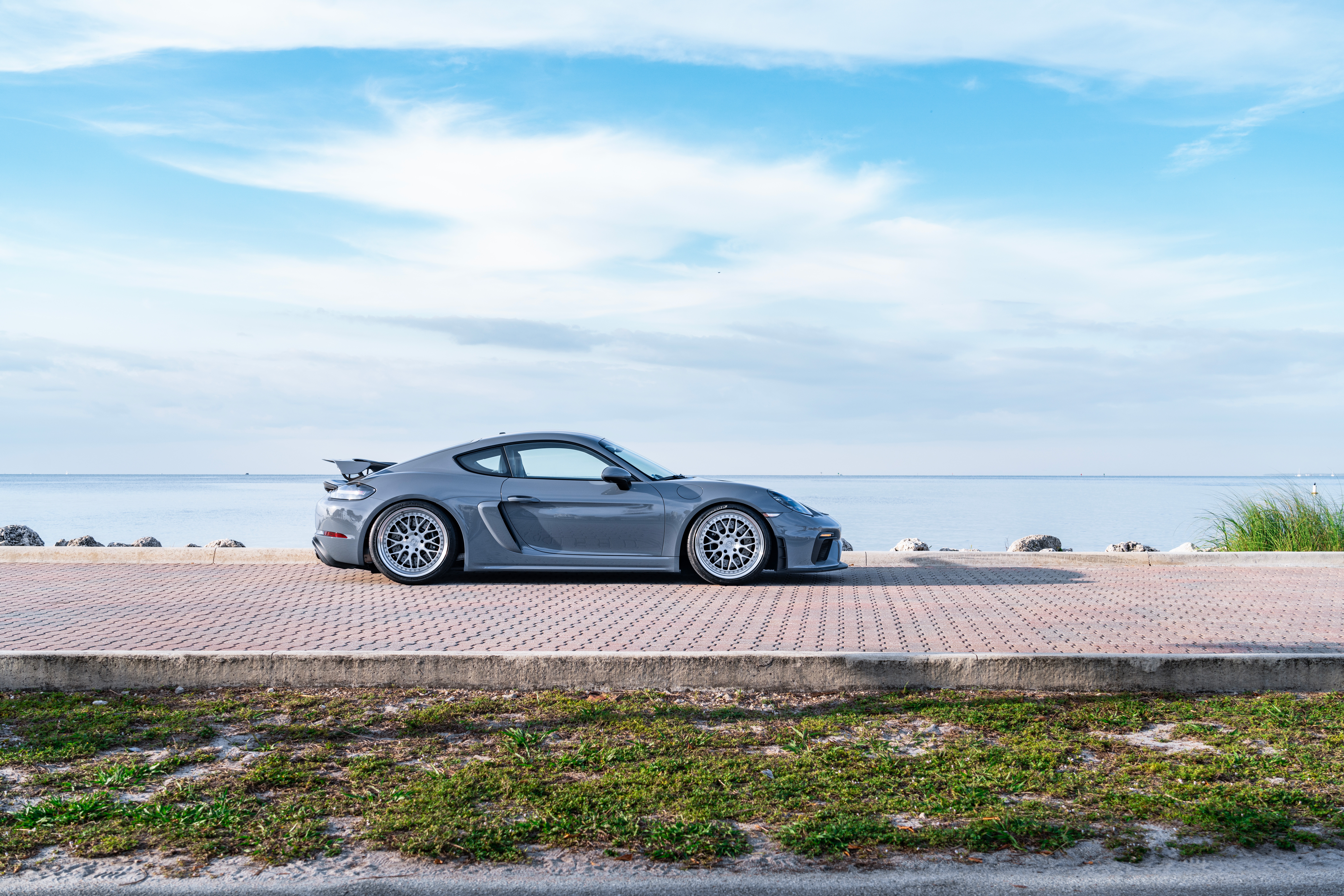 Porsche 718 Cayman GT4 parked by the ocean HD Wallpaper