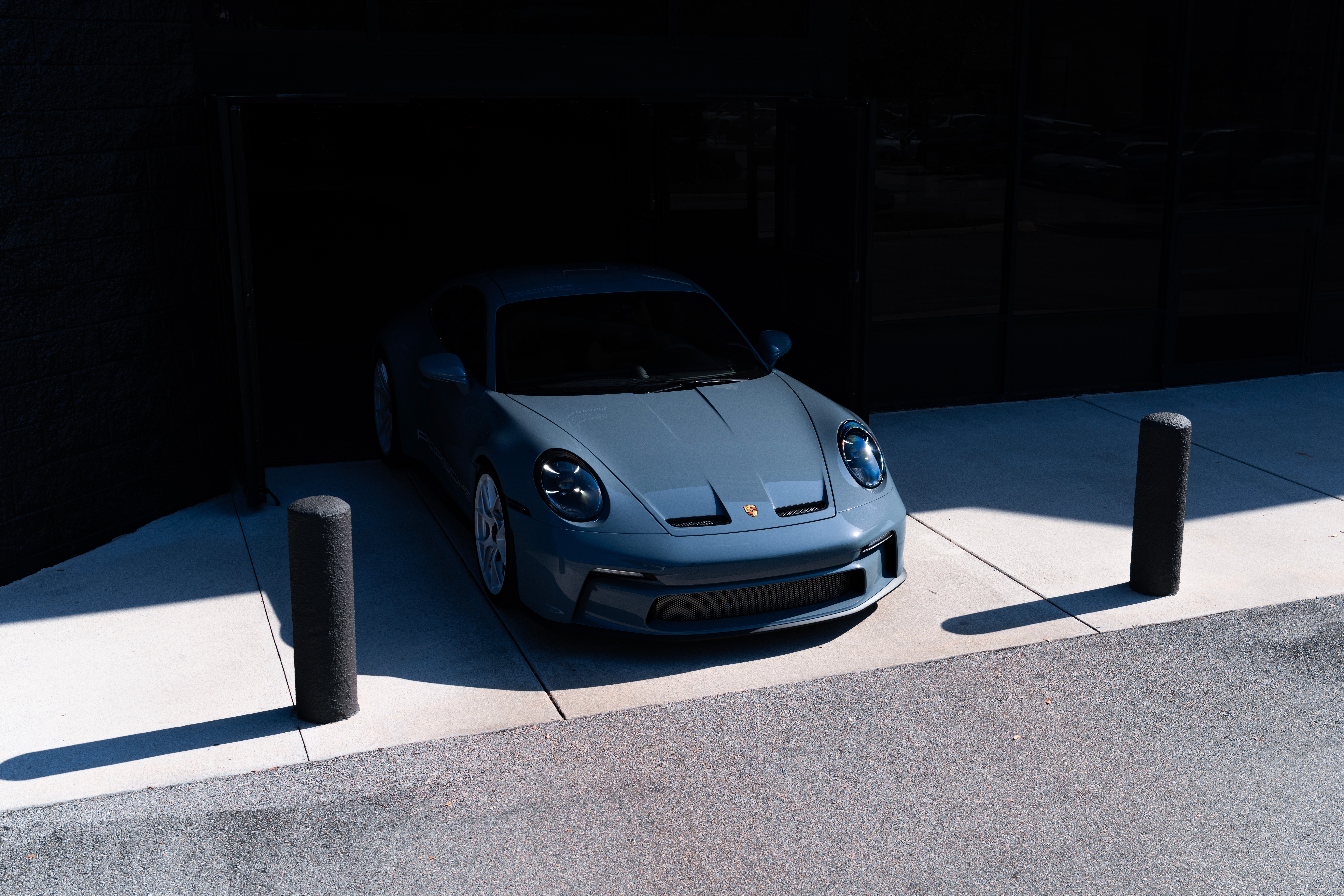 Porsche 992 St Shore Blue parked in a dark garage HD Wallpaper