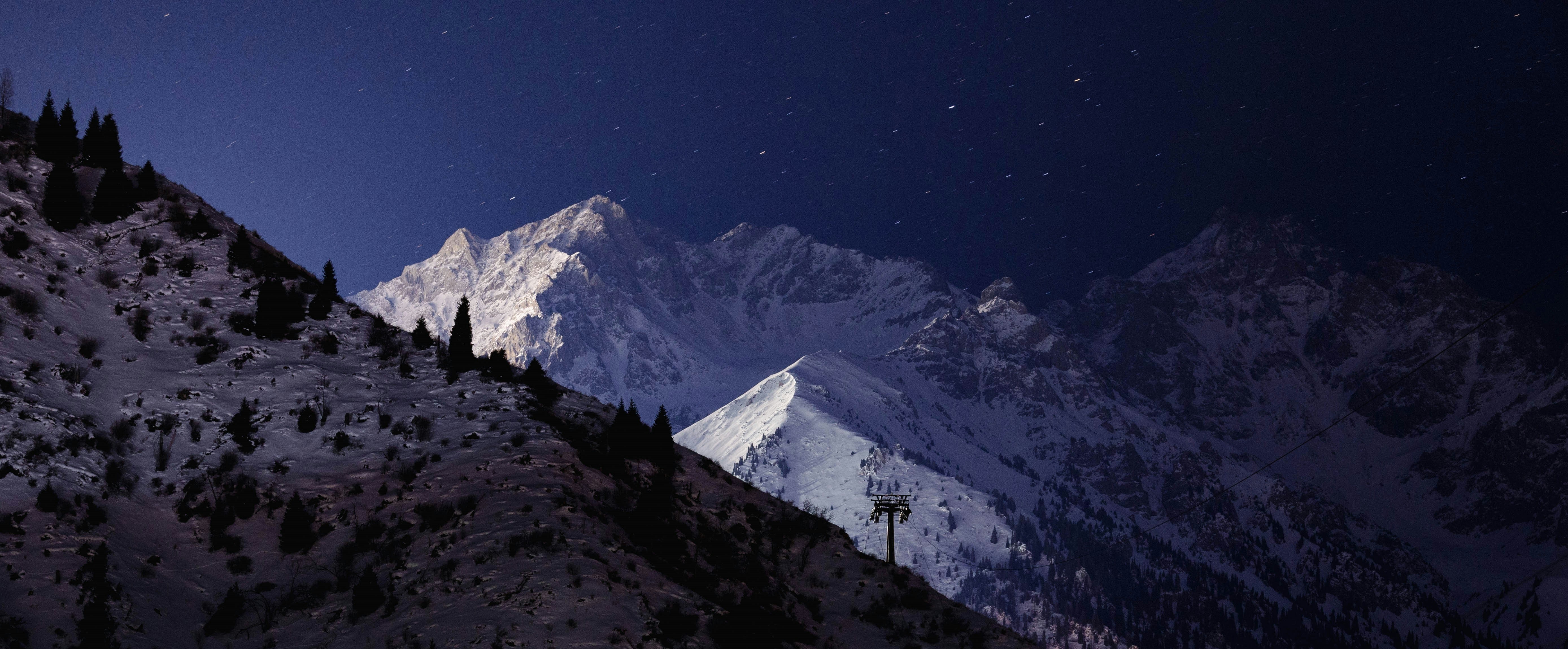 Night view of snowy mountains in Medeu District, Kazakhstan HD Wallpaper