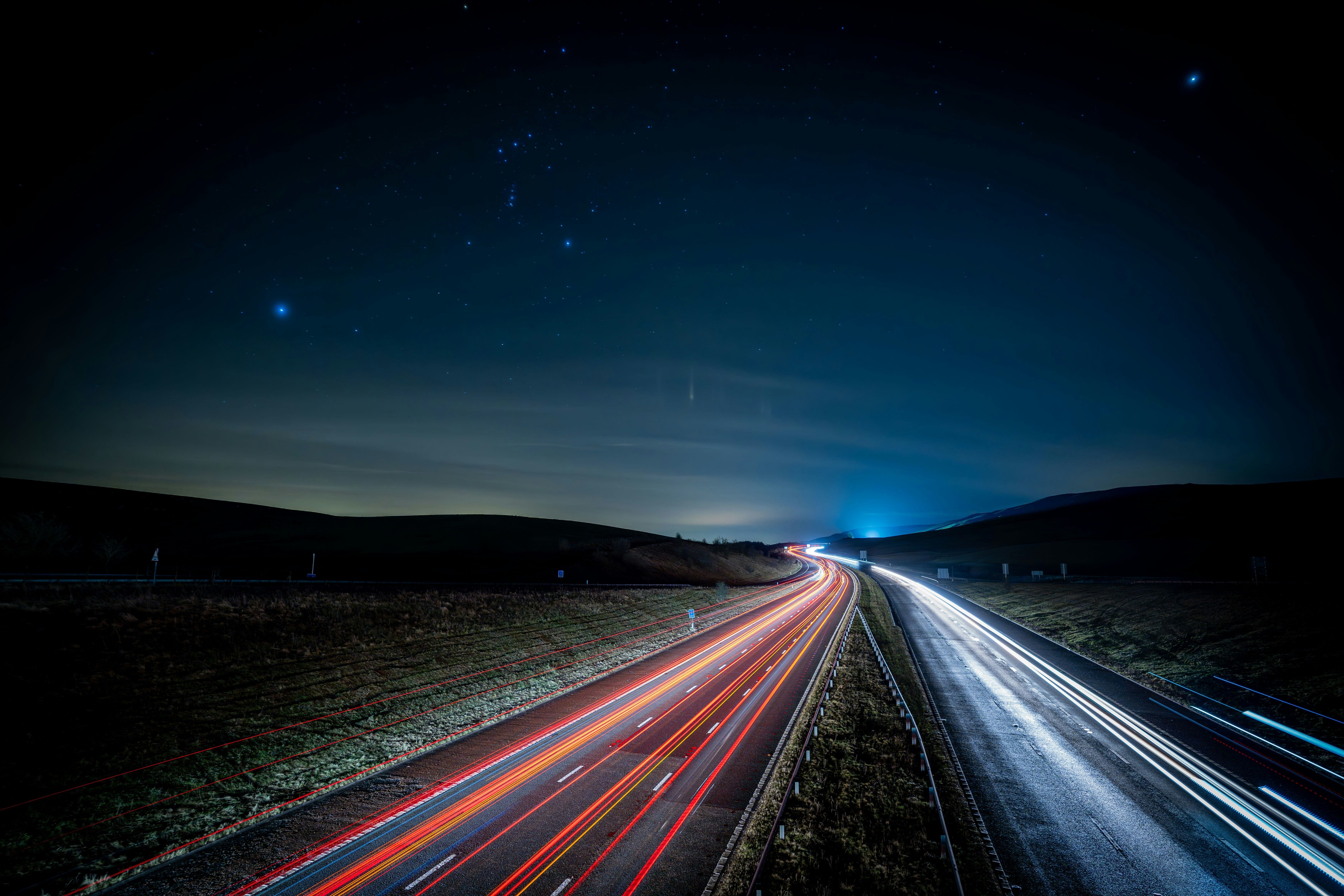 Long exposure of a highway at night with stars HD Wallpaper