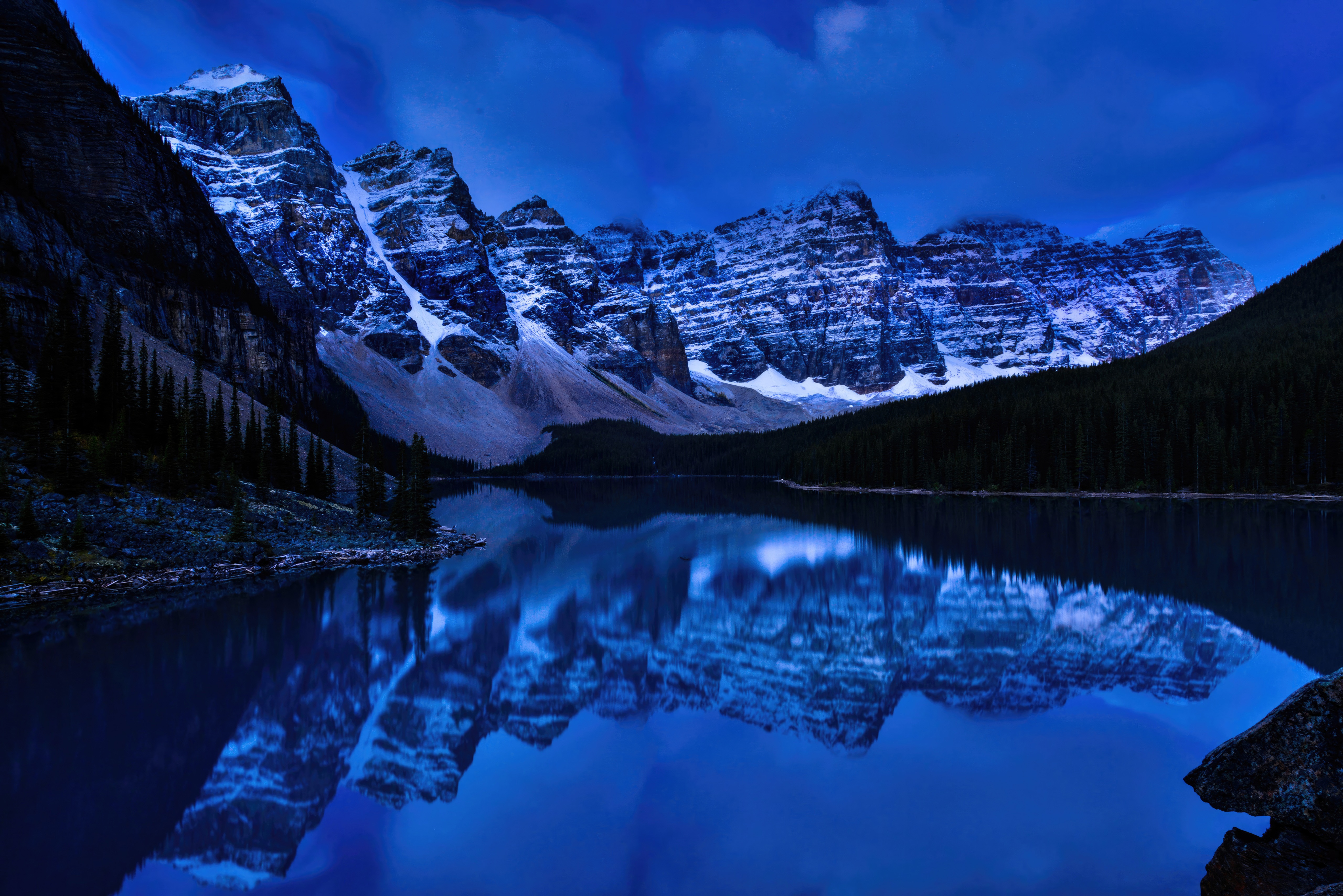 Pre-dawn tranquility at Moraine Lake with snow-capped mountains HD Wallpaper