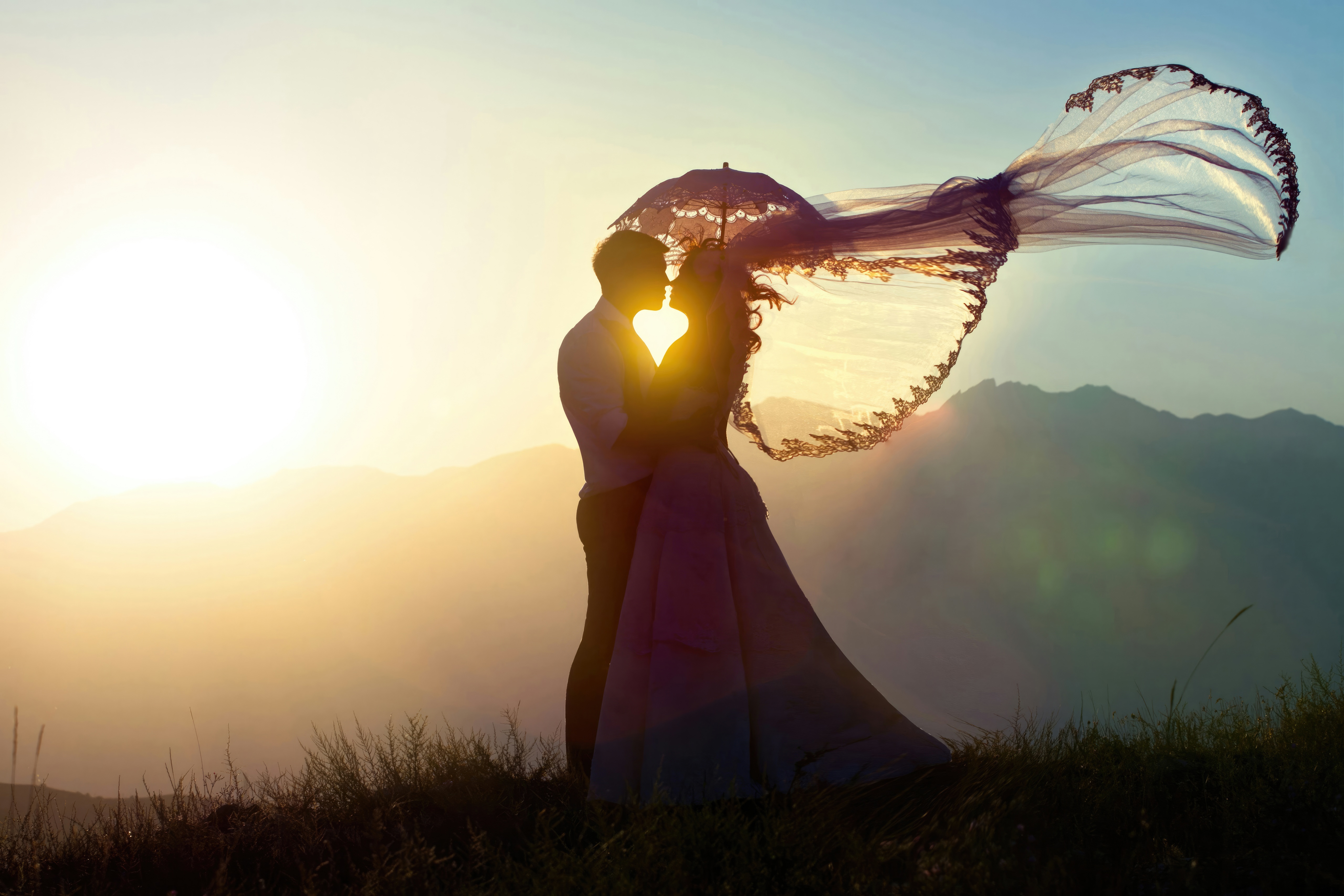 Bride and Groom Silhouette Kissing at Sunset HD Wallpaper