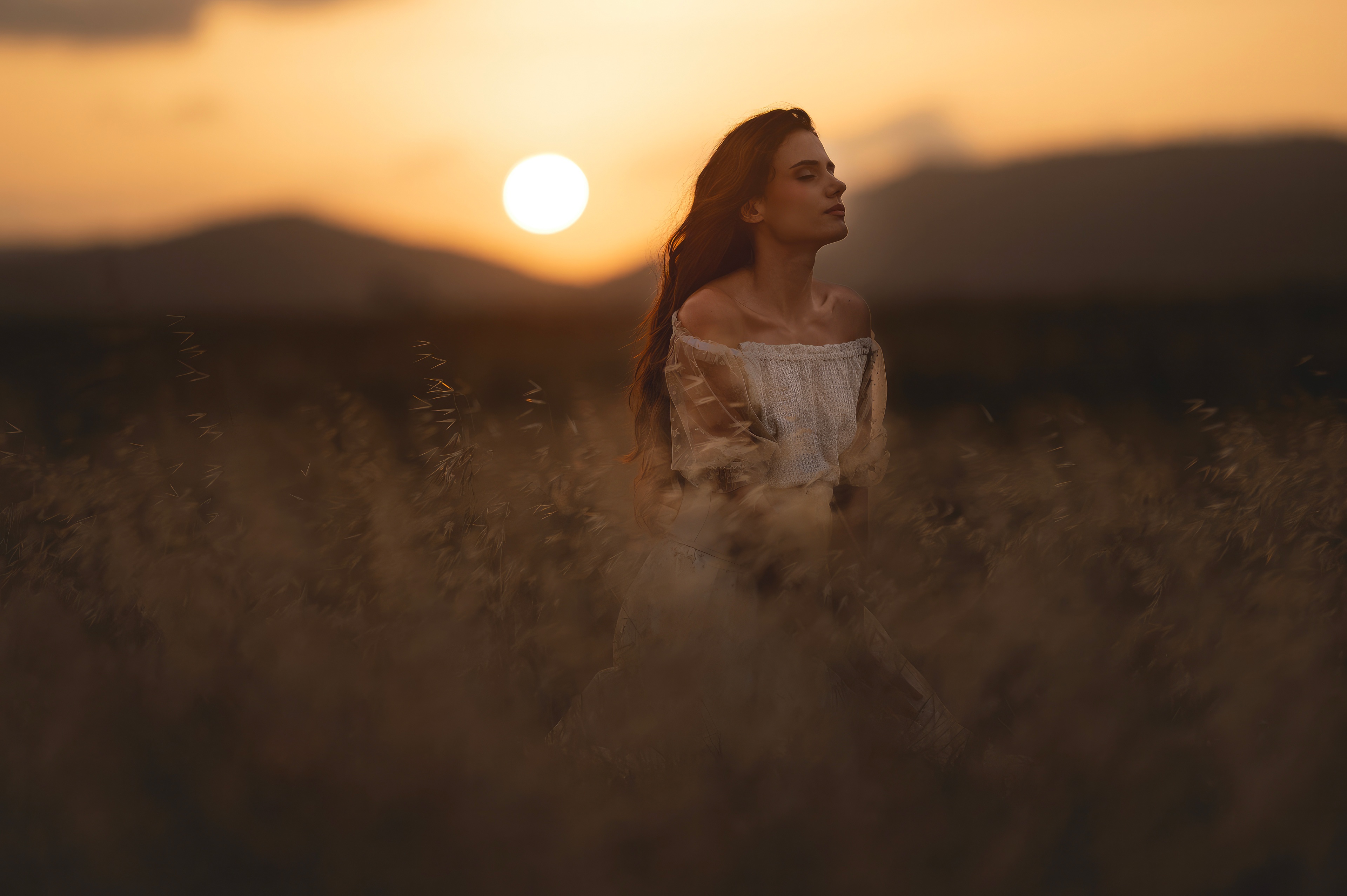 Girl in a field at sunset HD Wallpaper
