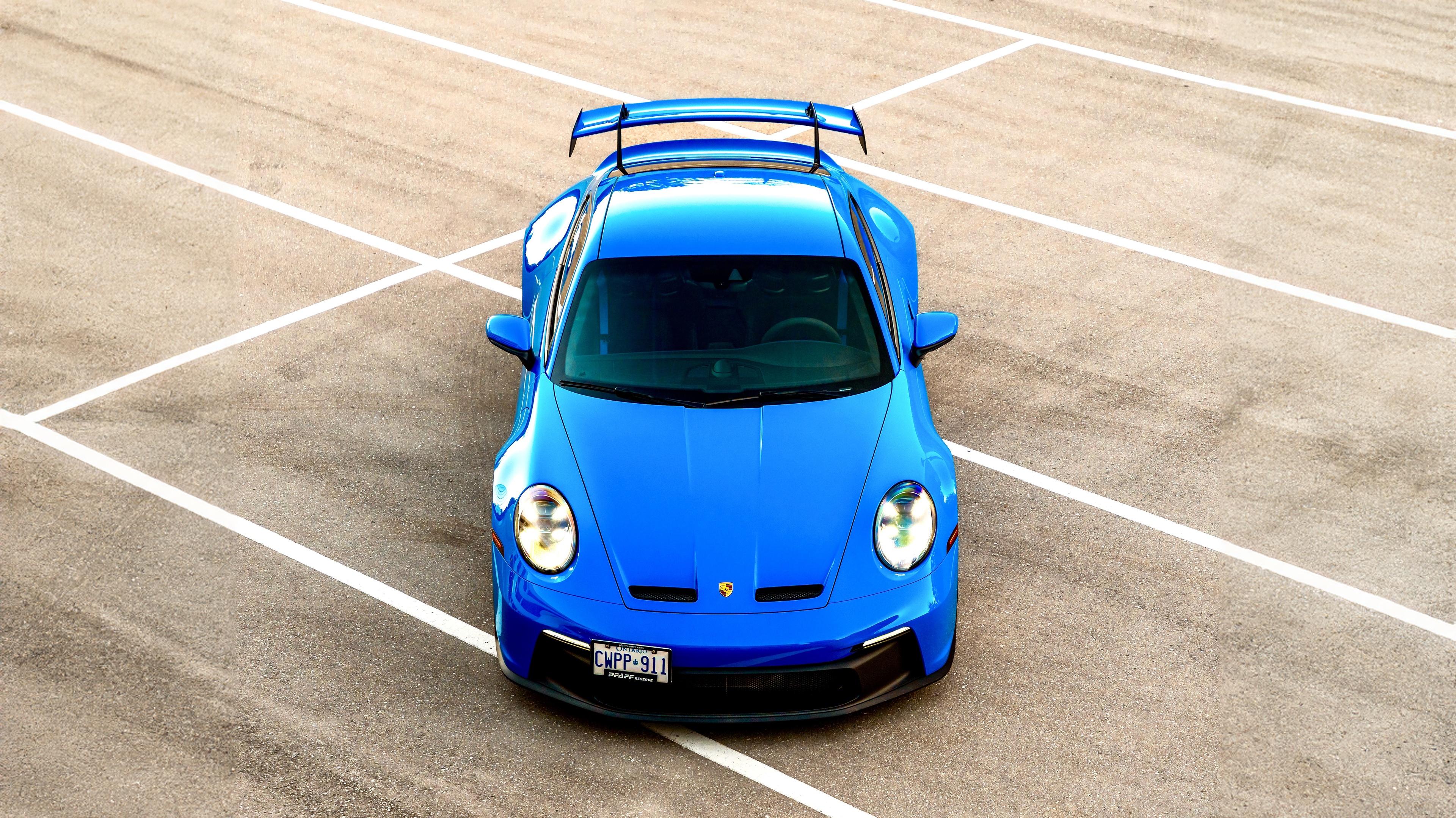 Blue 2024 Porsche 911 GT3 on asphalt HD Wallpaper