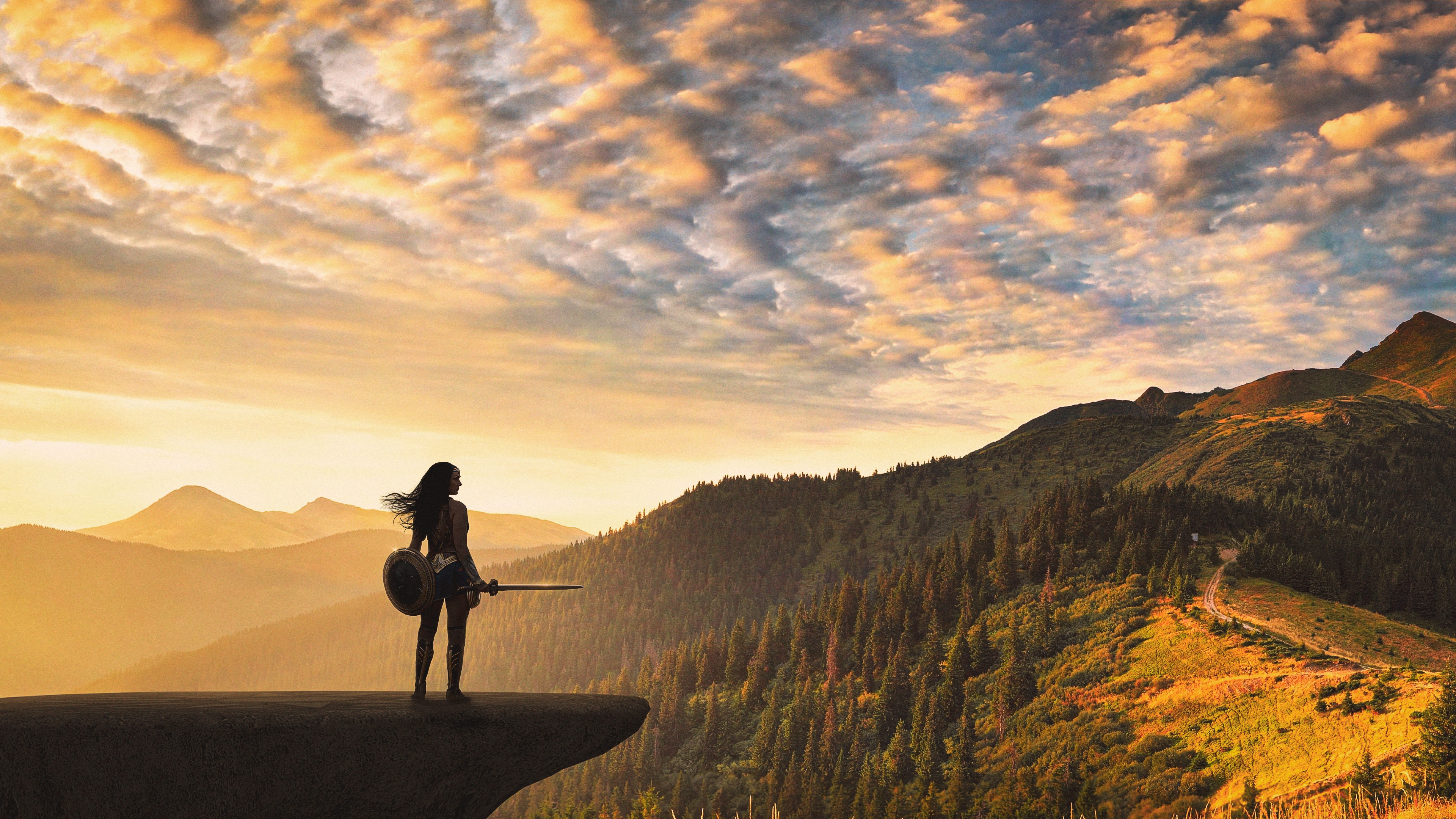 Wonder Woman on a cliff overlooking mountains HD Wallpaper