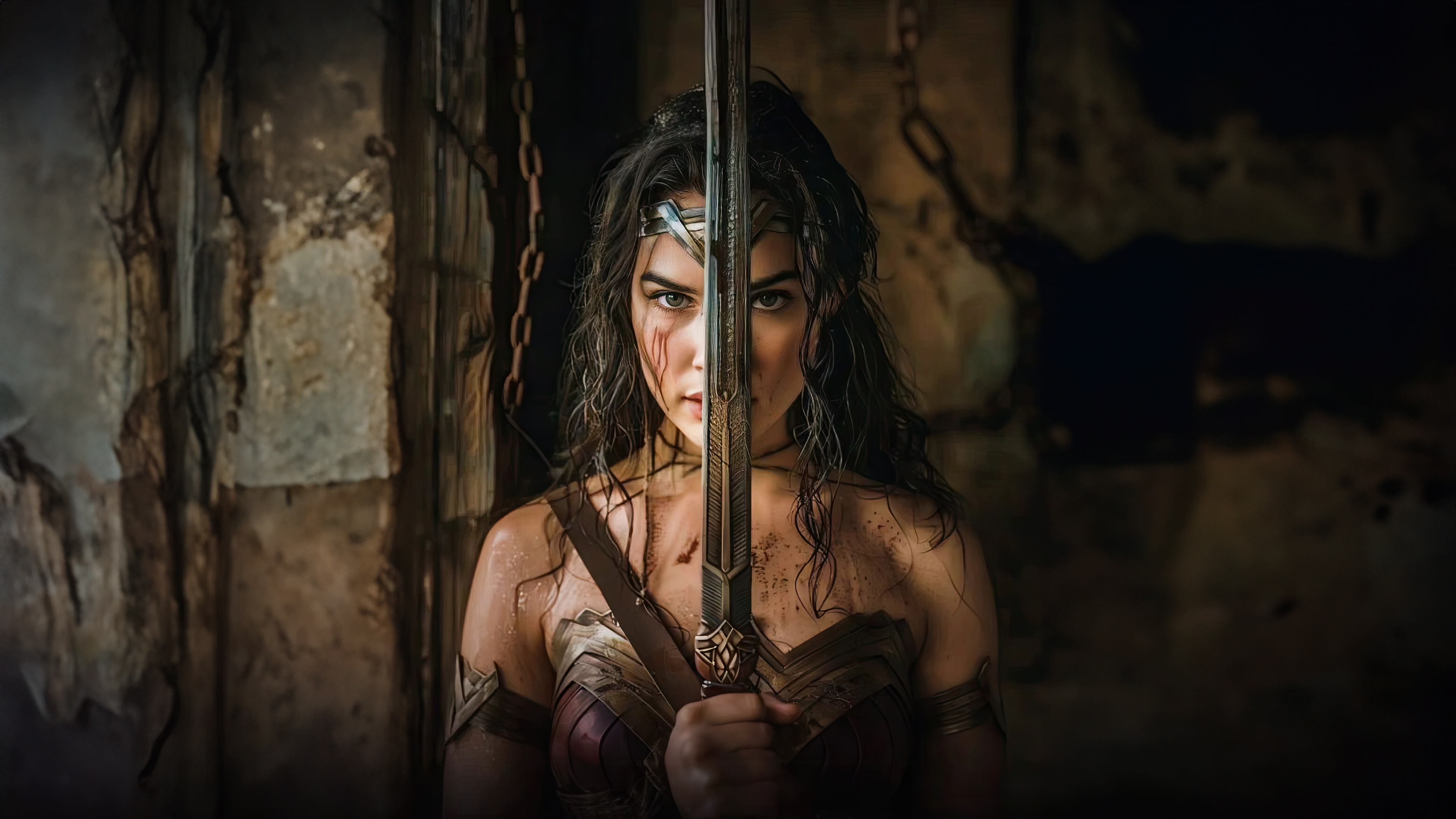 Wonder Woman holding a sword in a dark cave HD Wallpaper