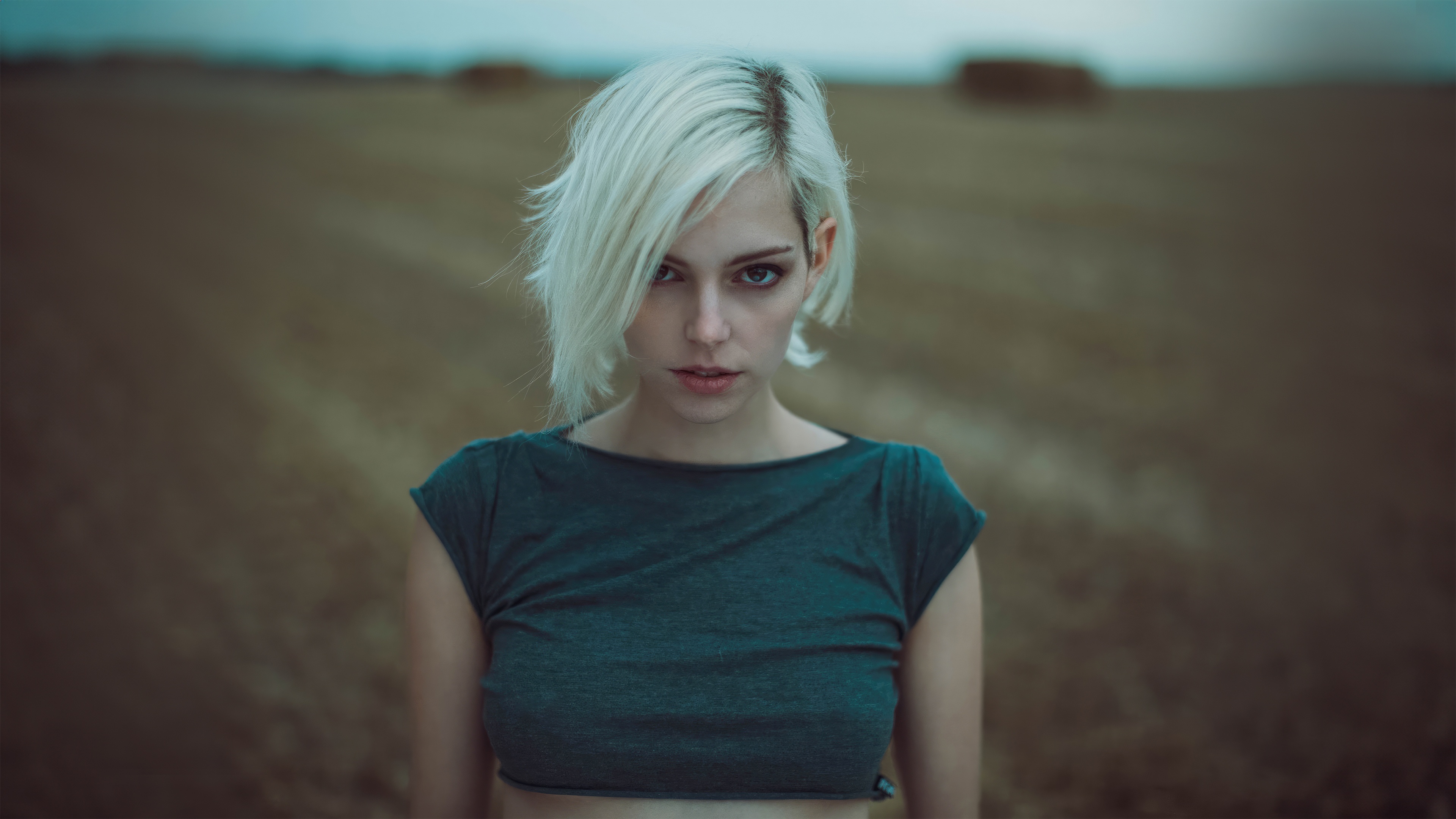 Woman with short white hair in a field HD Wallpaper