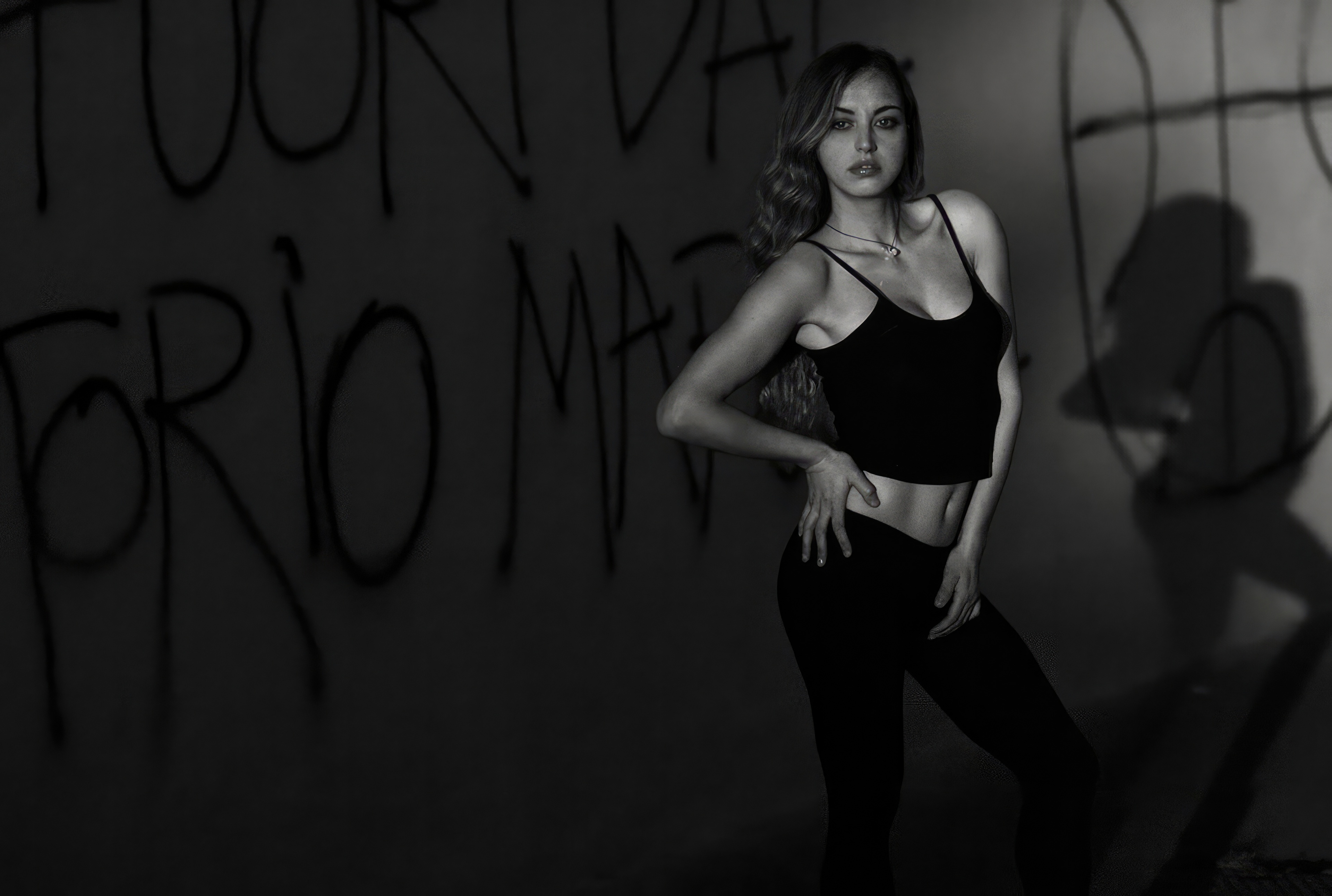 Girl in black clothing against graffiti wall HD Wallpaper