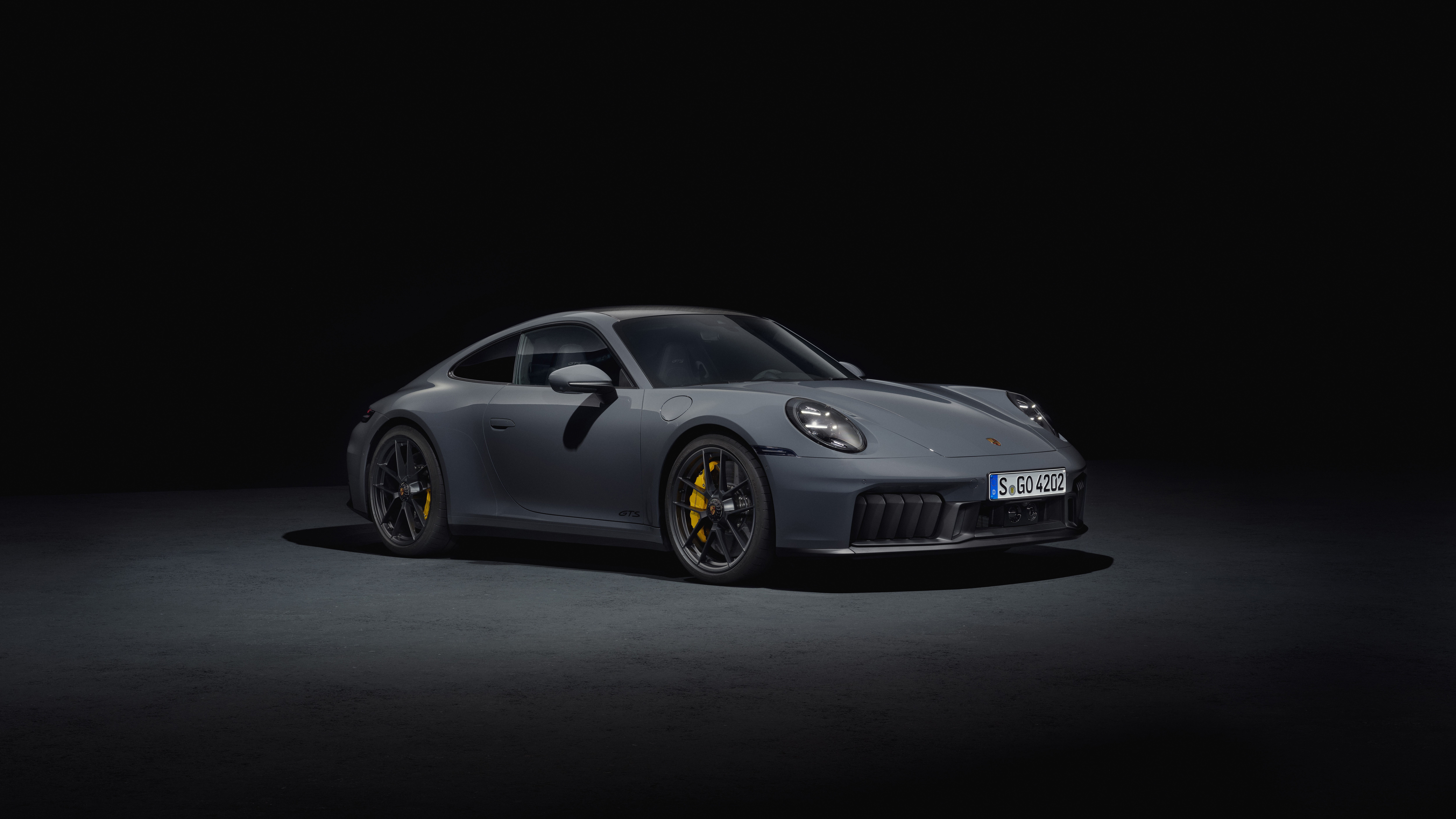 Porsche 911 Carrera GTS in a dark studio HD Wallpaper
