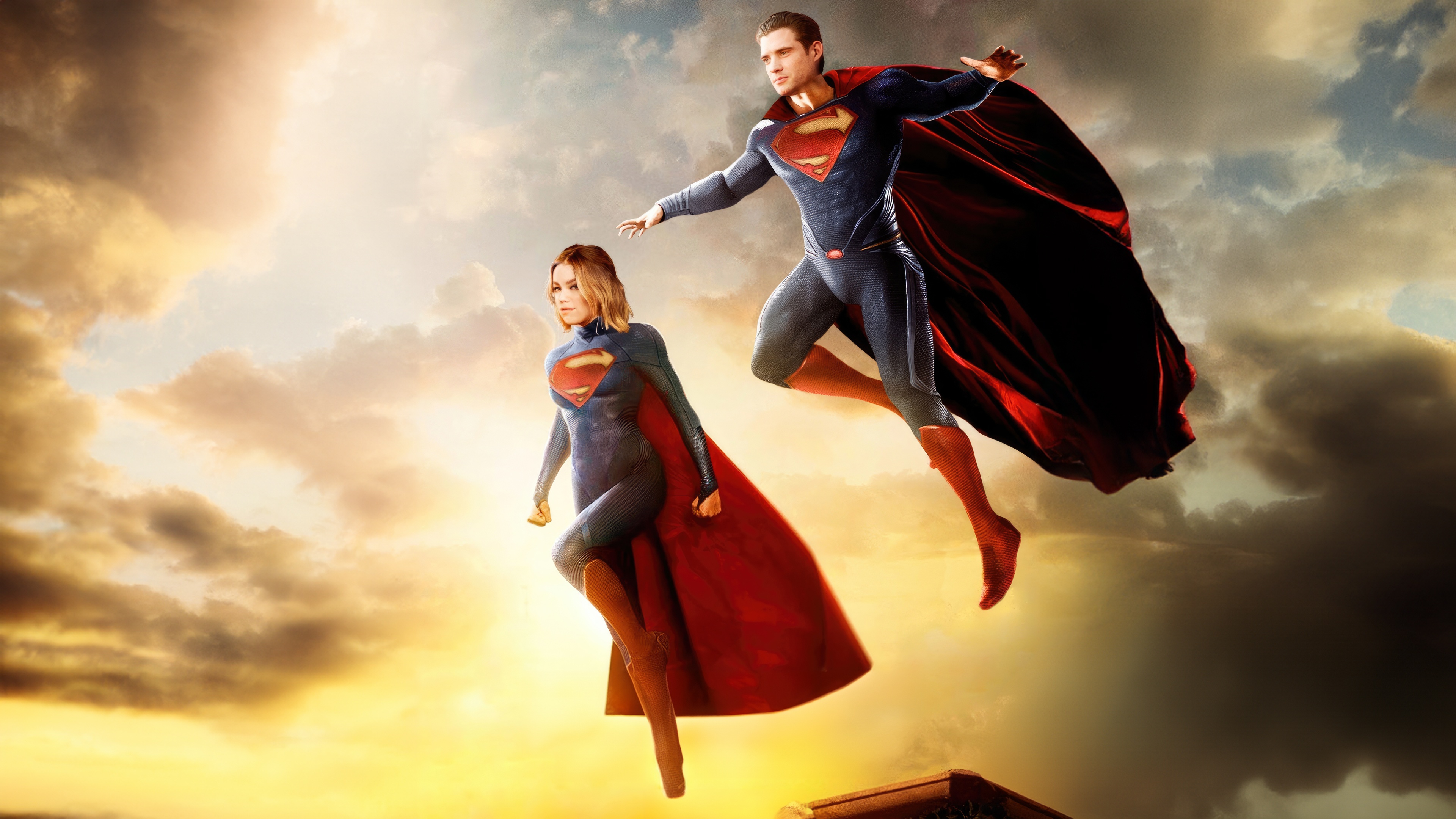 Superman and Supergirl flying in the sky HD Wallpaper
