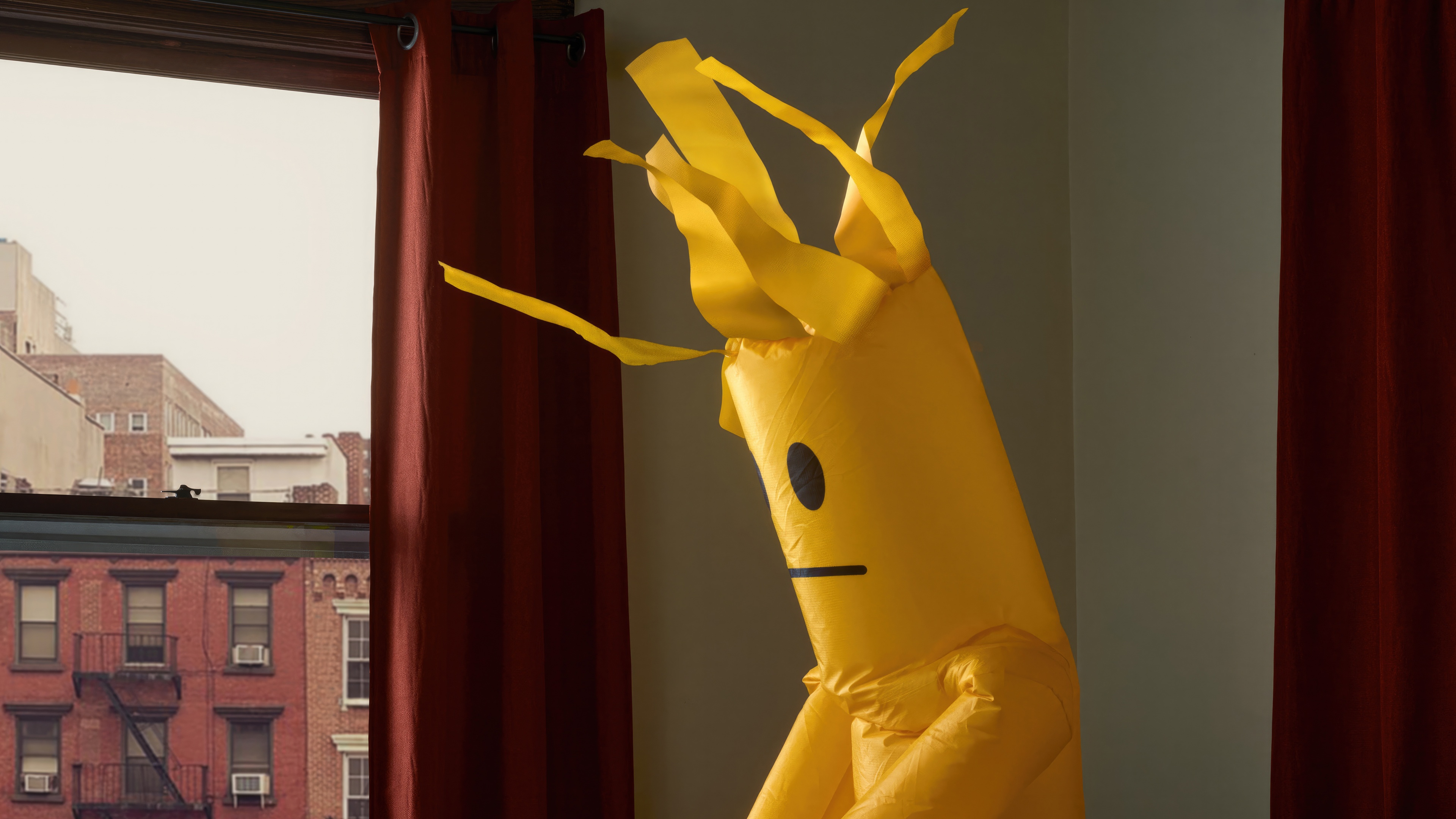 Yellow inflatable tube man with a sad face HD Wallpaper