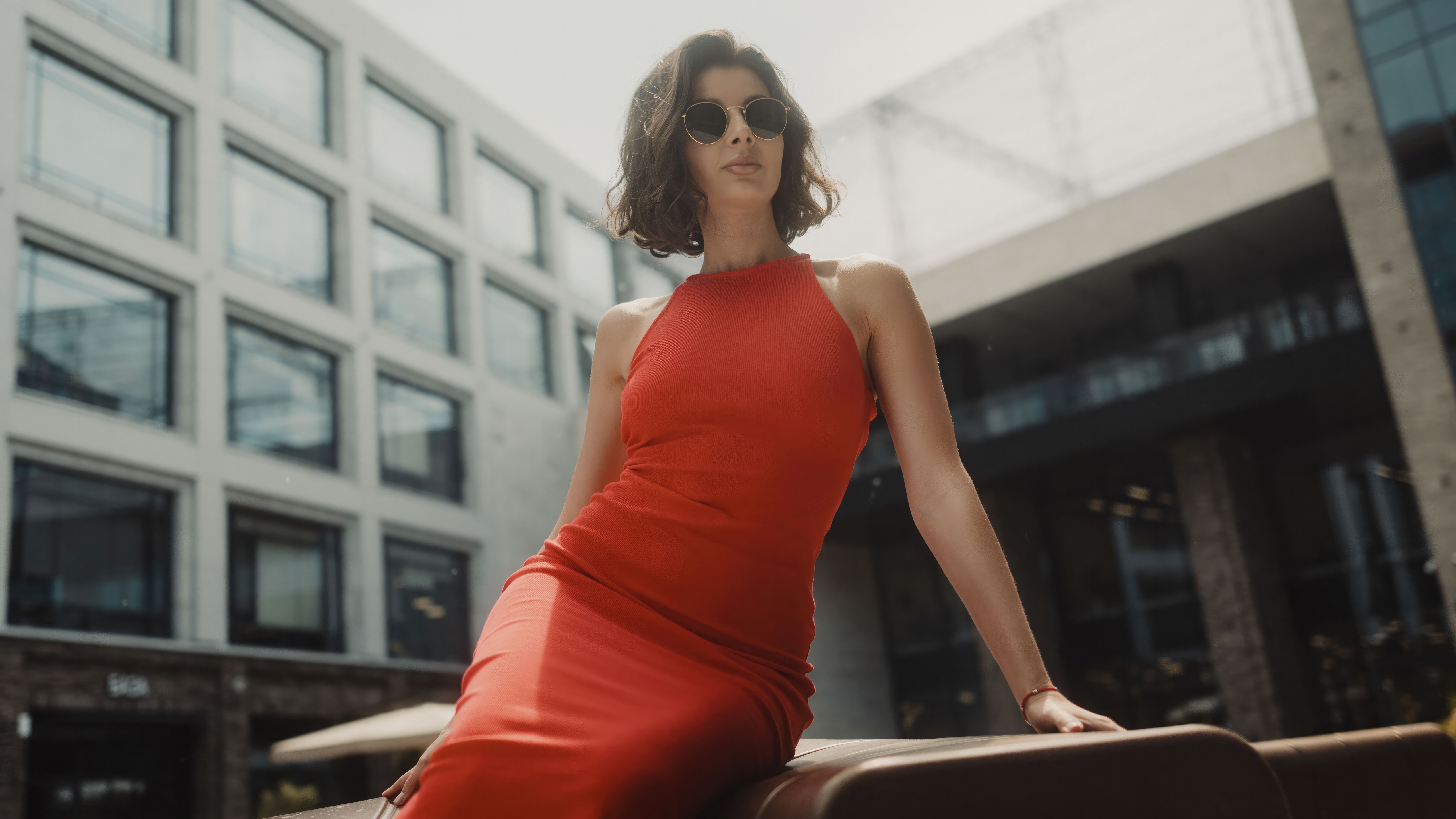 Woman in red dress and sunglasses outdoors HD Wallpaper