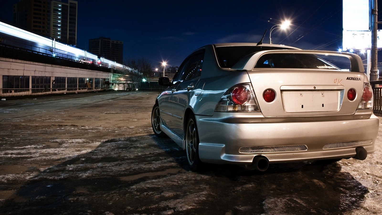 Silver Lexus IS sedan with spoiler at night HD Wallpaper