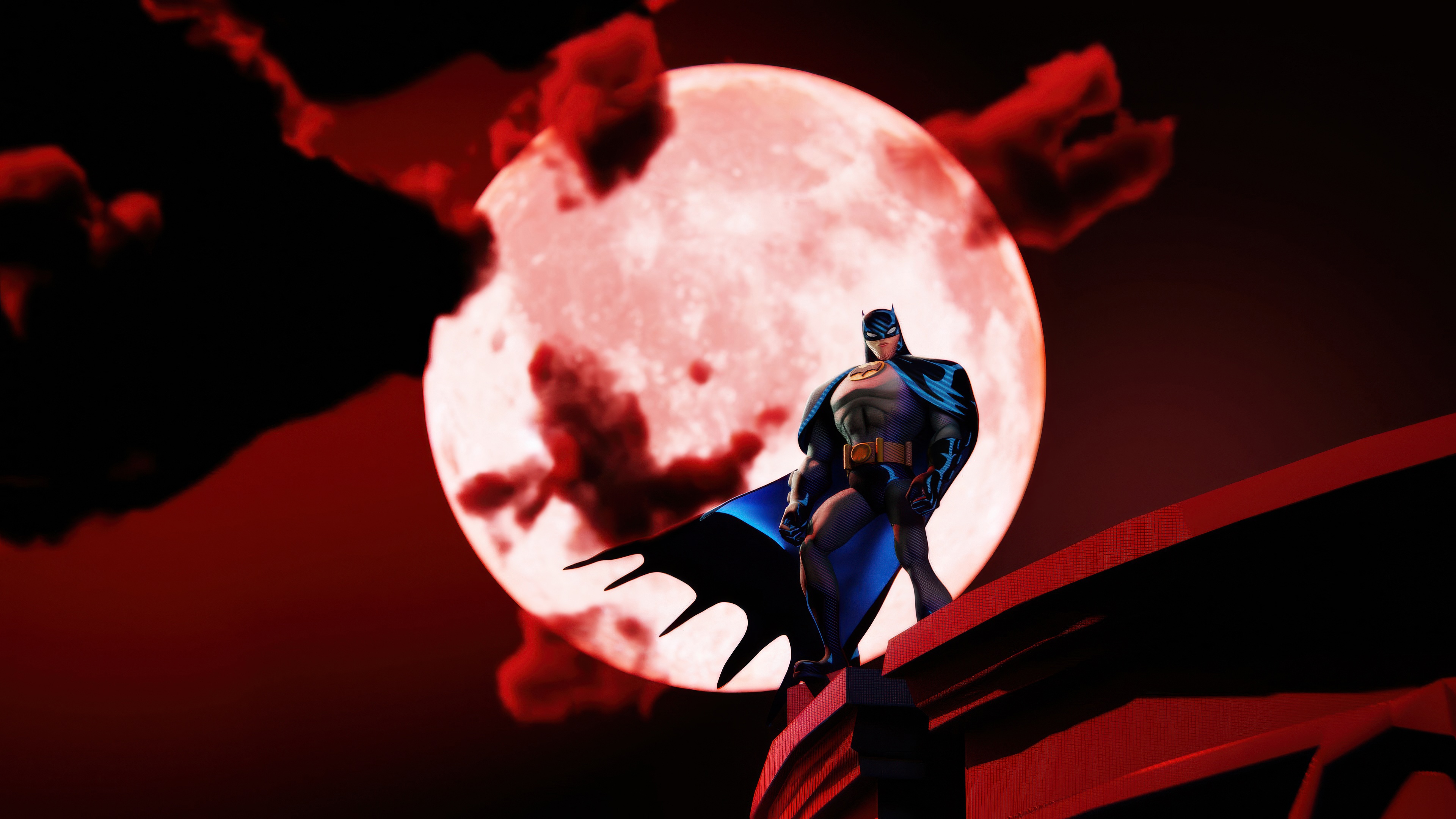 Batman standing on a building ledge with a red moon HD Wallpaper