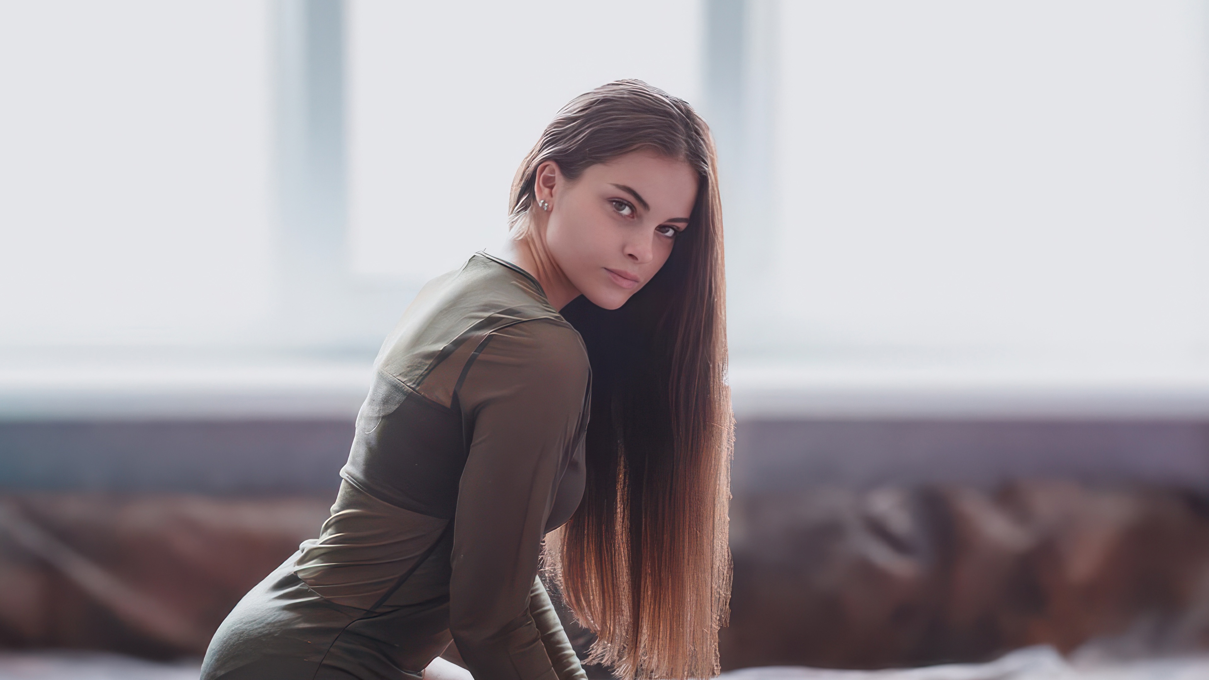 Young woman with long brown hair wearing a green top HD Wallpaper
