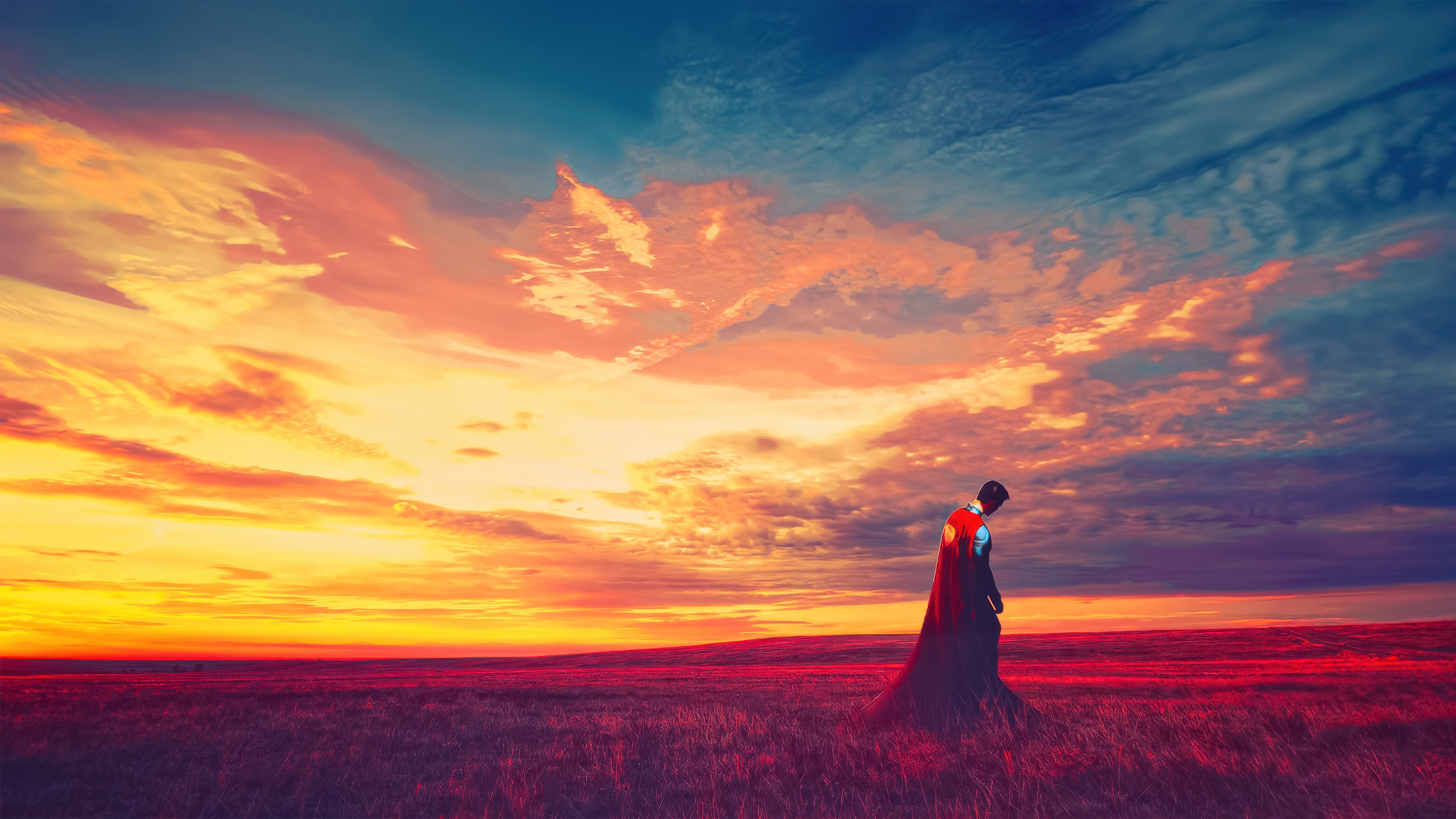 Superman standing in a field at sunset HD Wallpaper