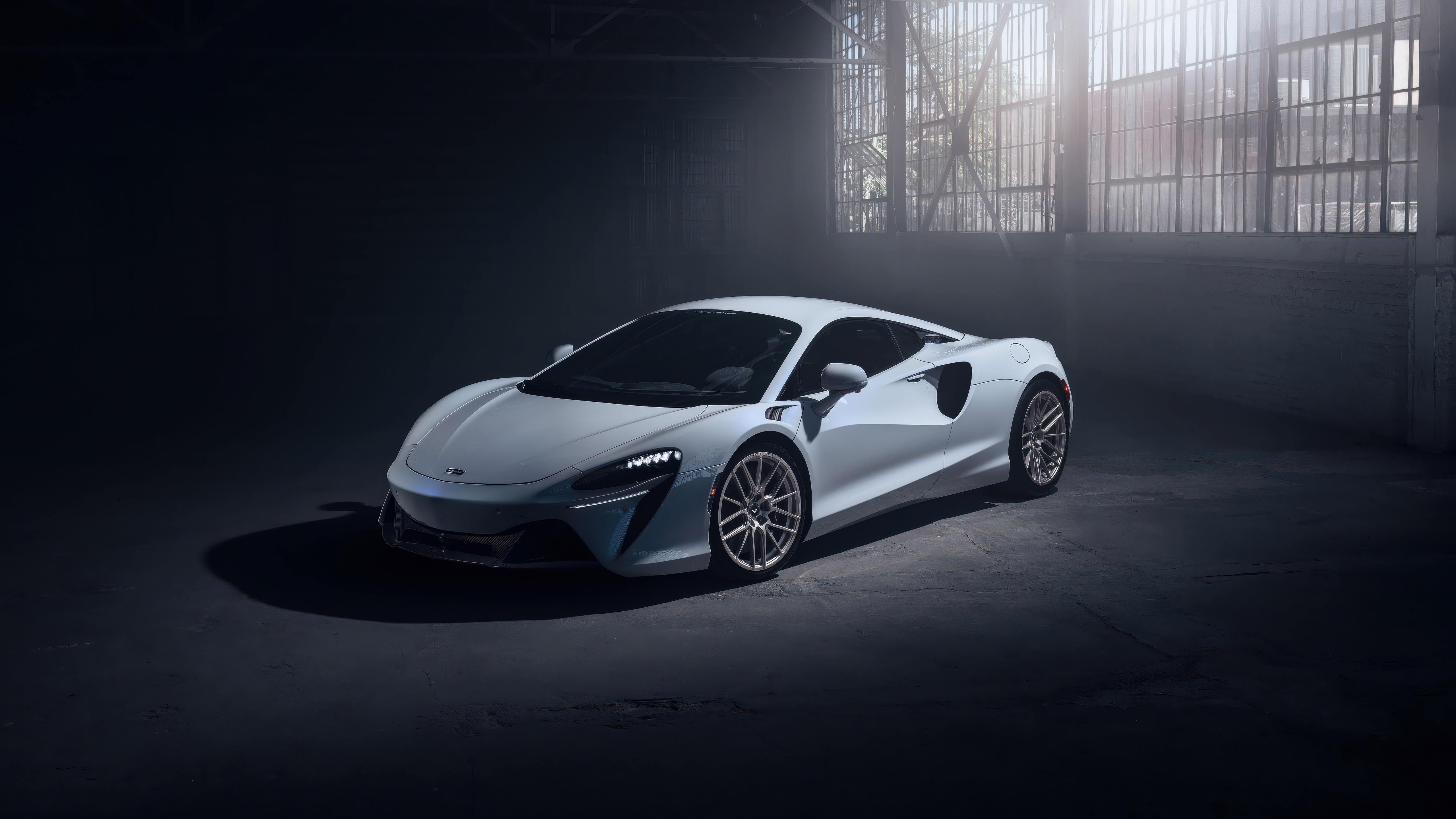White McLaren Artura in a dimly lit garage HD Wallpaper