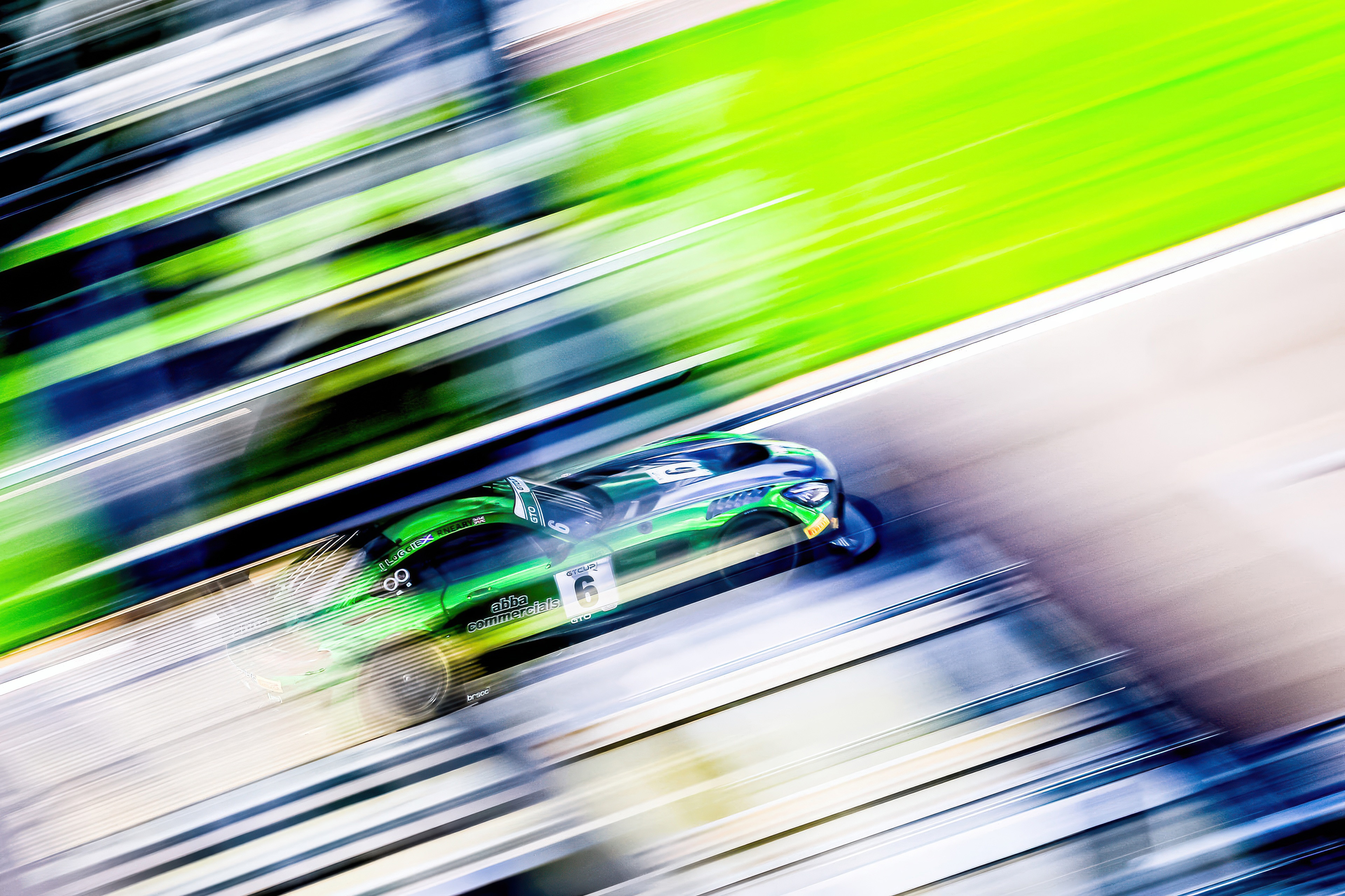 Green Mercedes AMG GT3 race car on a track HD Wallpaper