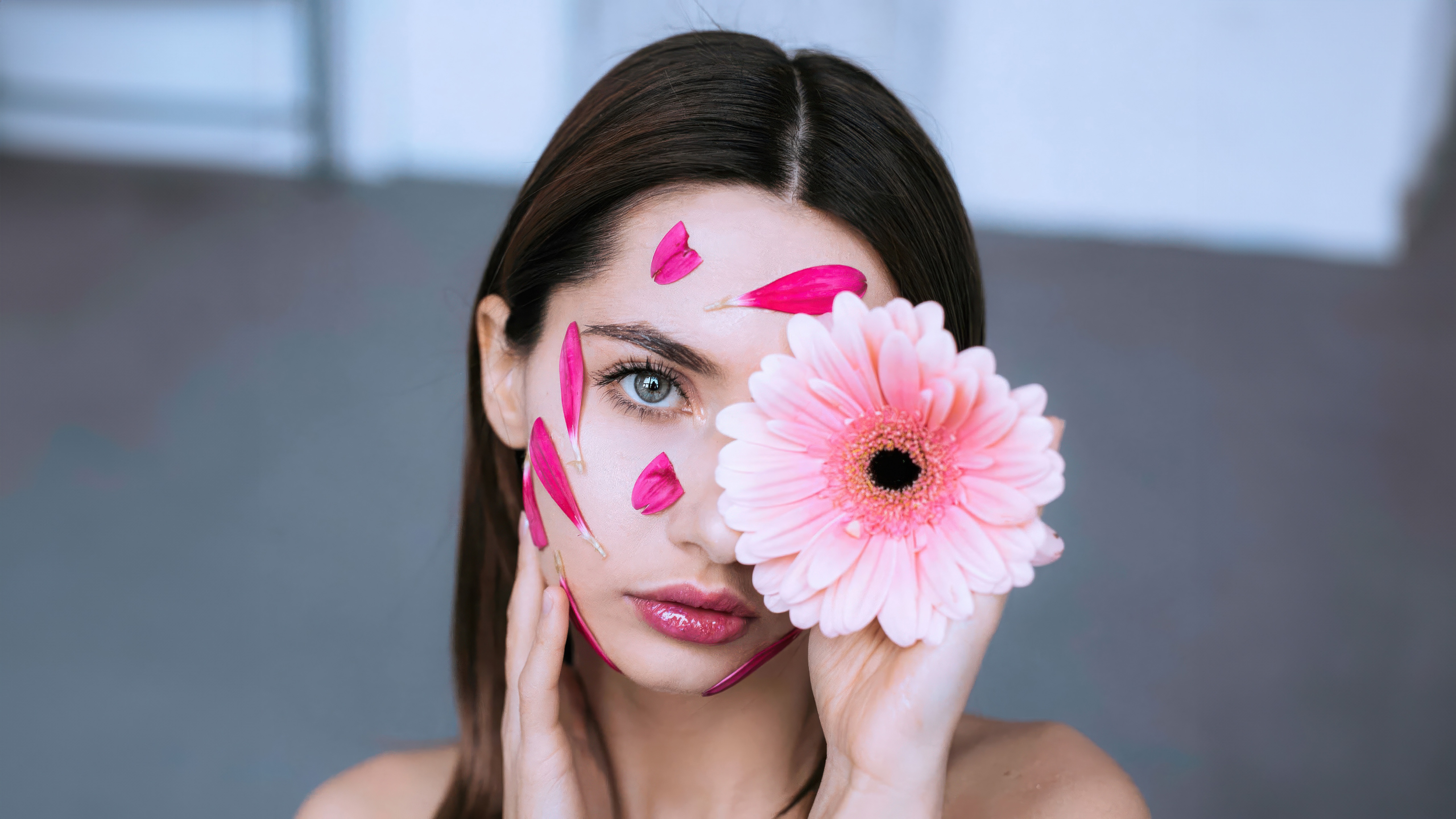 Woman with pink flower and petals on face HD Wallpaper