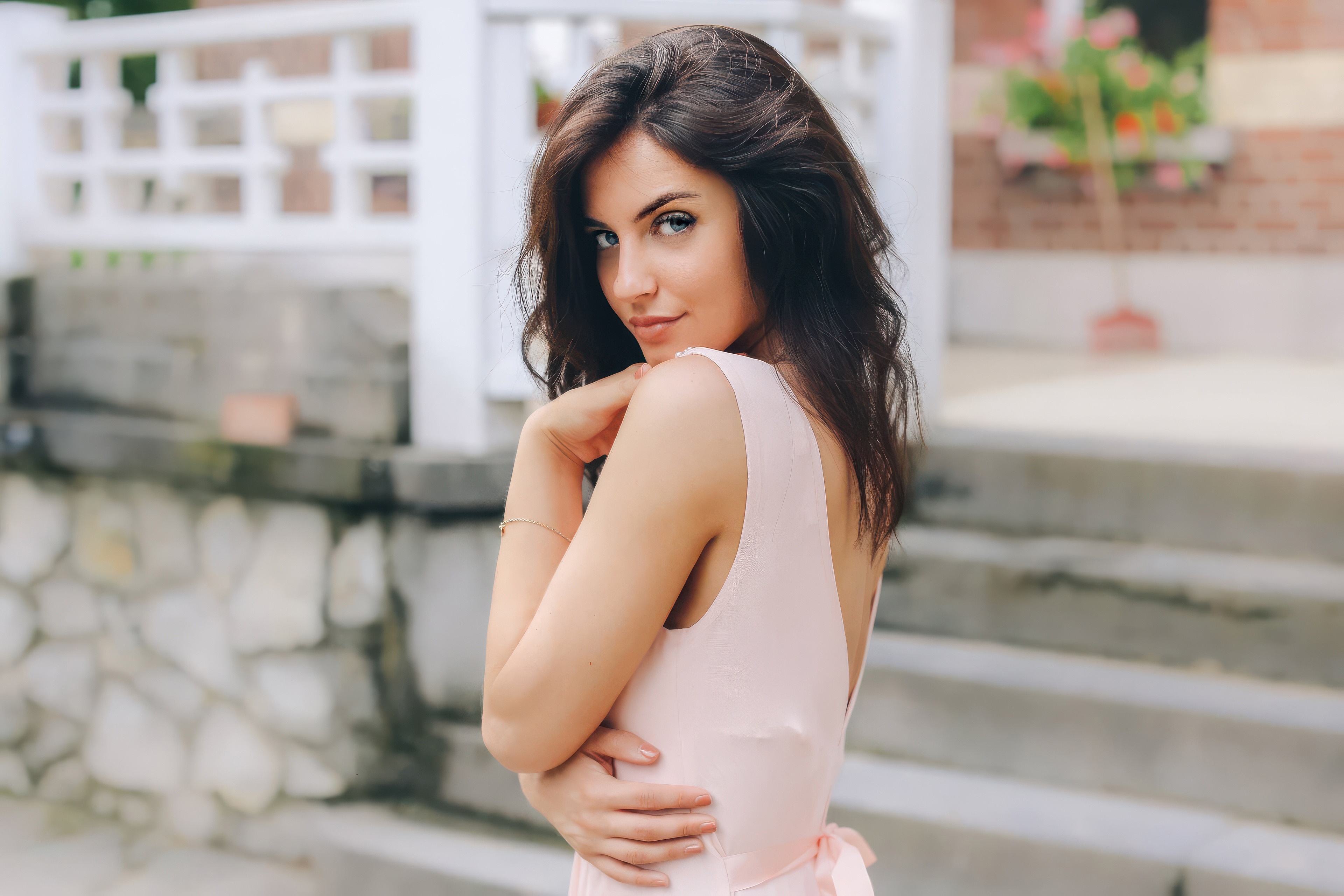 Woman in a pink dress with a playful glance HD Wallpaper
