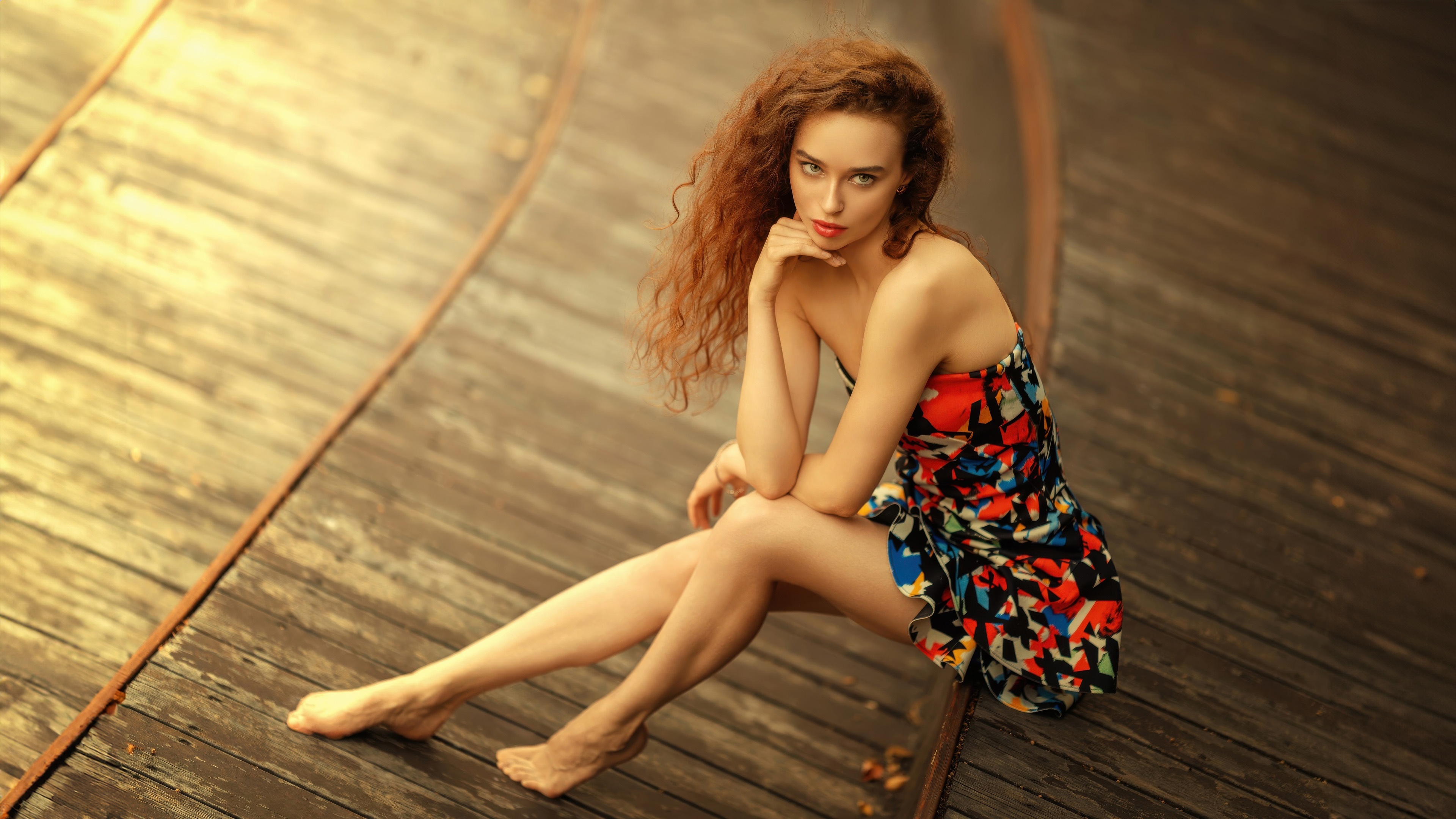 Girl with red curly hair sitting on wooden planks HD Wallpaper