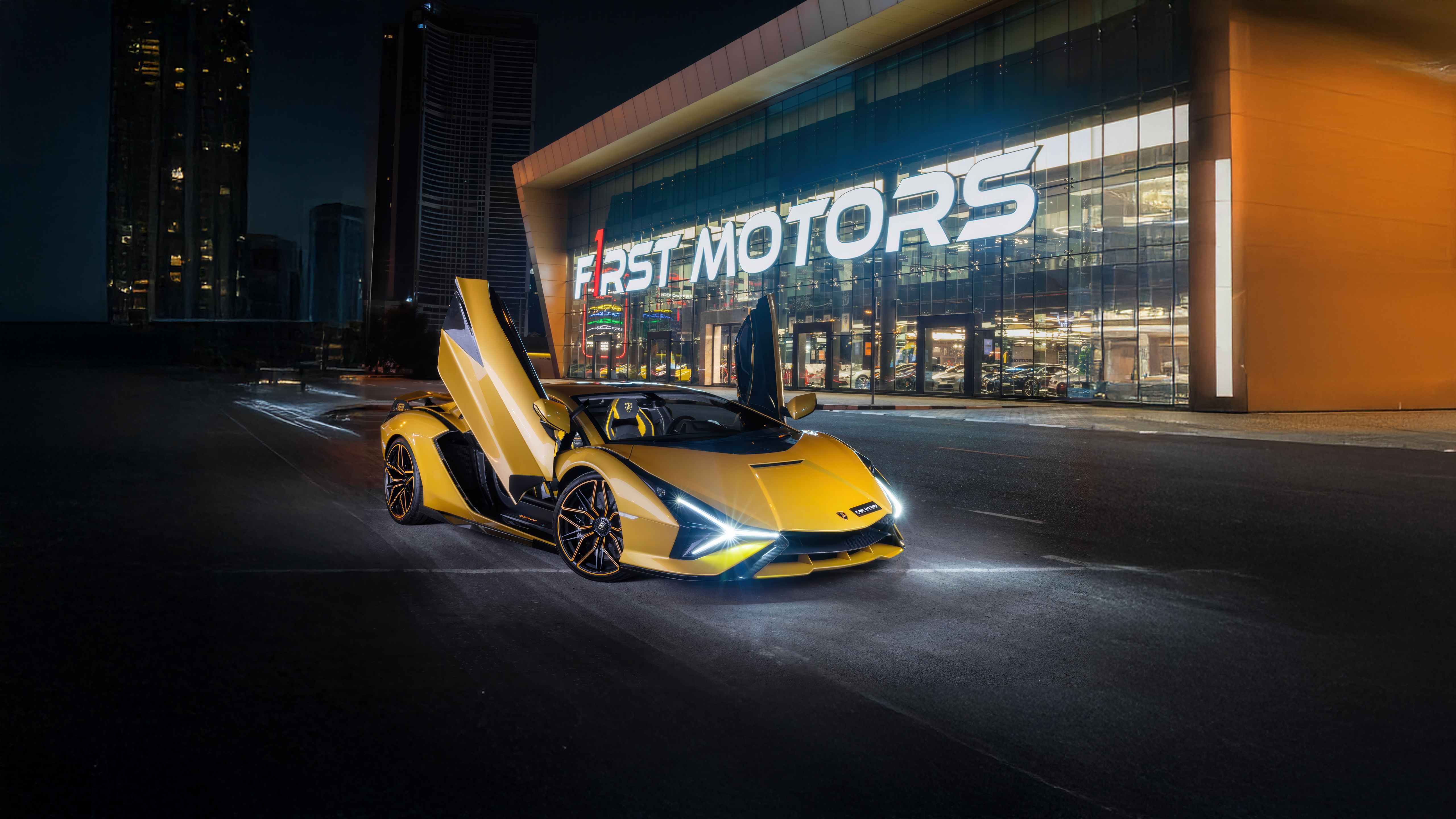 Yellow Lamborghini Sian parked in front of First Motors dealership at night HD Wallpaper