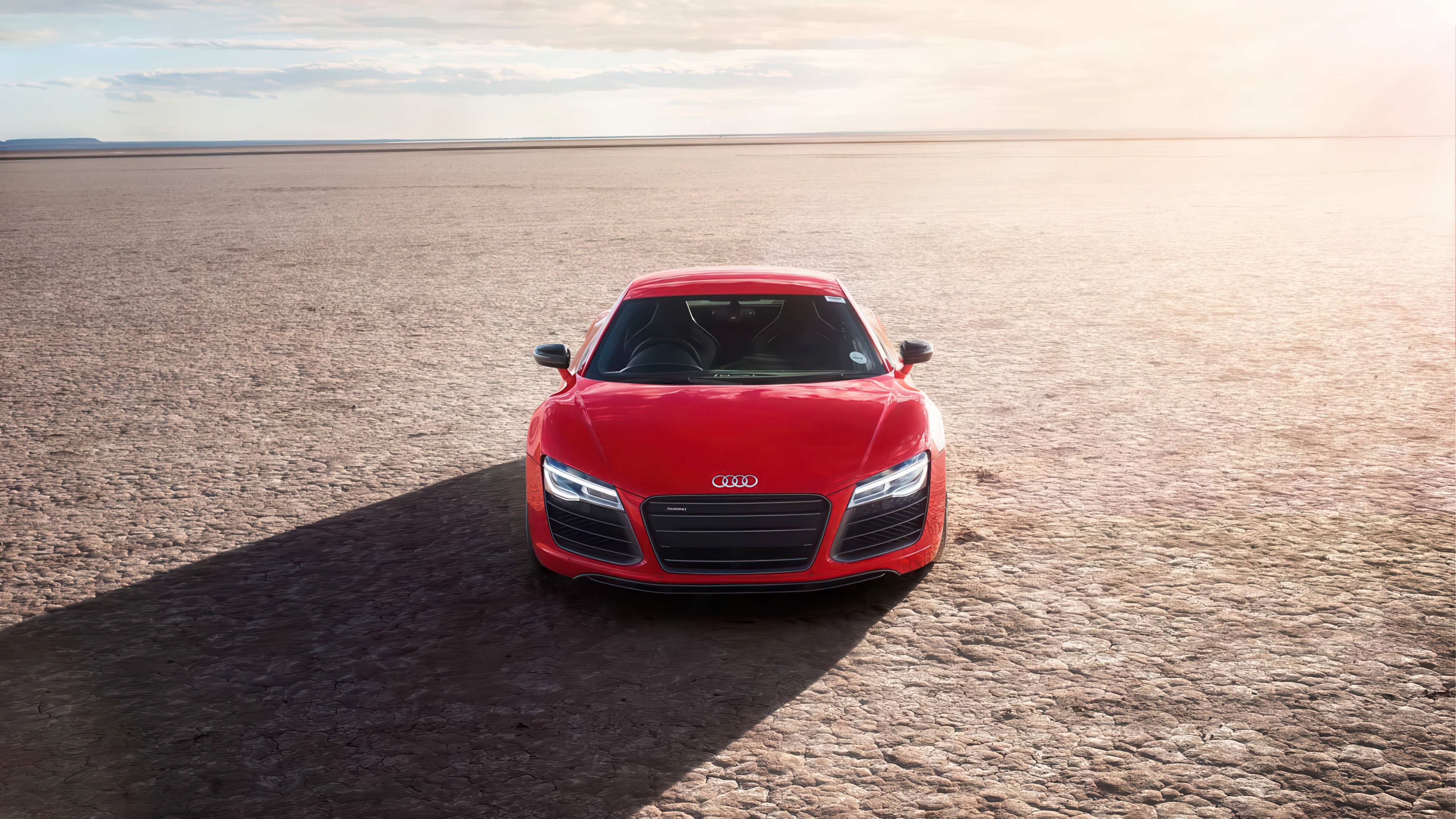 Red Audi R8 in a barren landscape HD Wallpaper