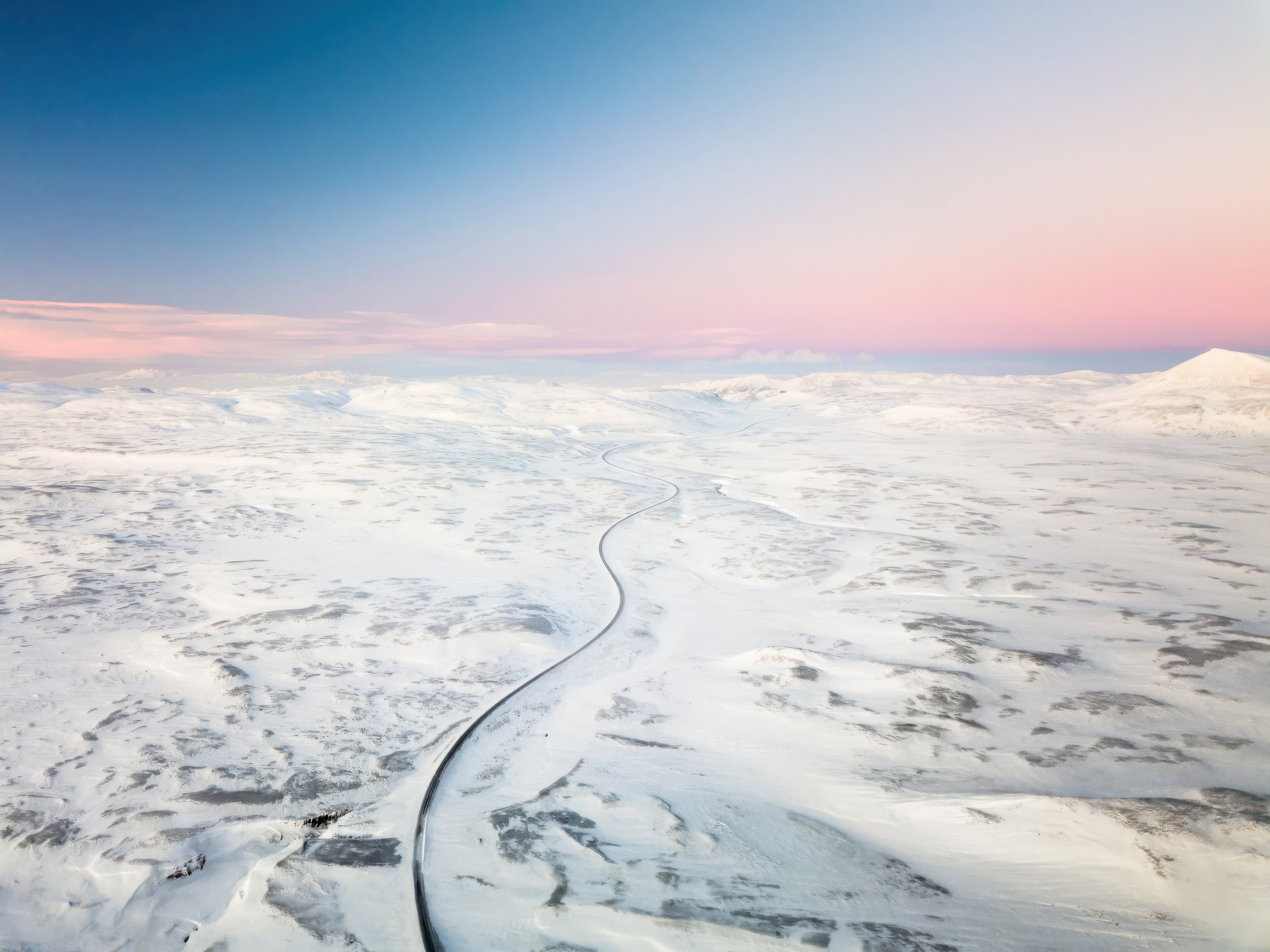 Road through snowy landscape in Iceland HD Wallpaper
