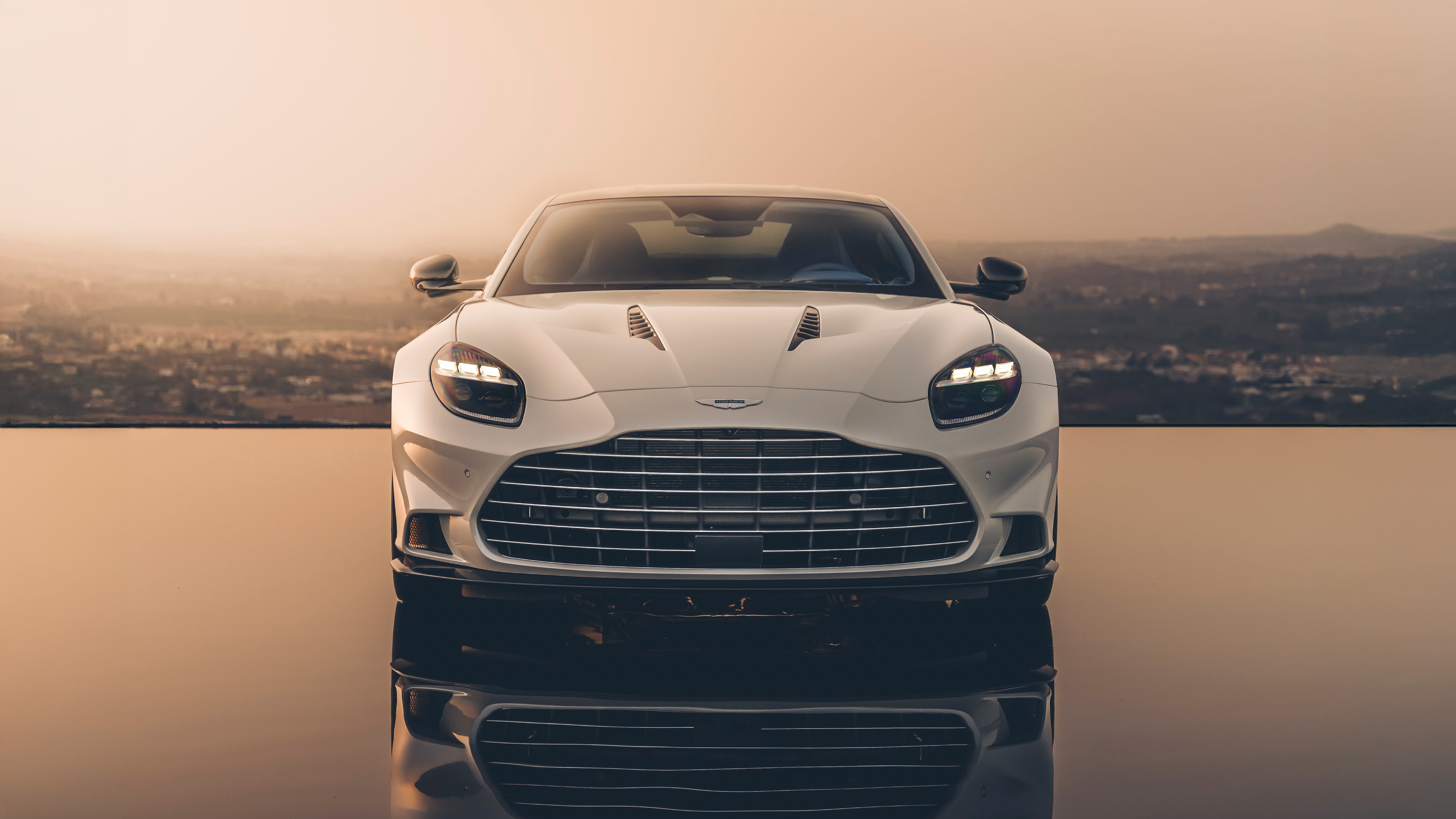 White Aston Martin Vanquish 2024 on reflective surface HD Wallpaper