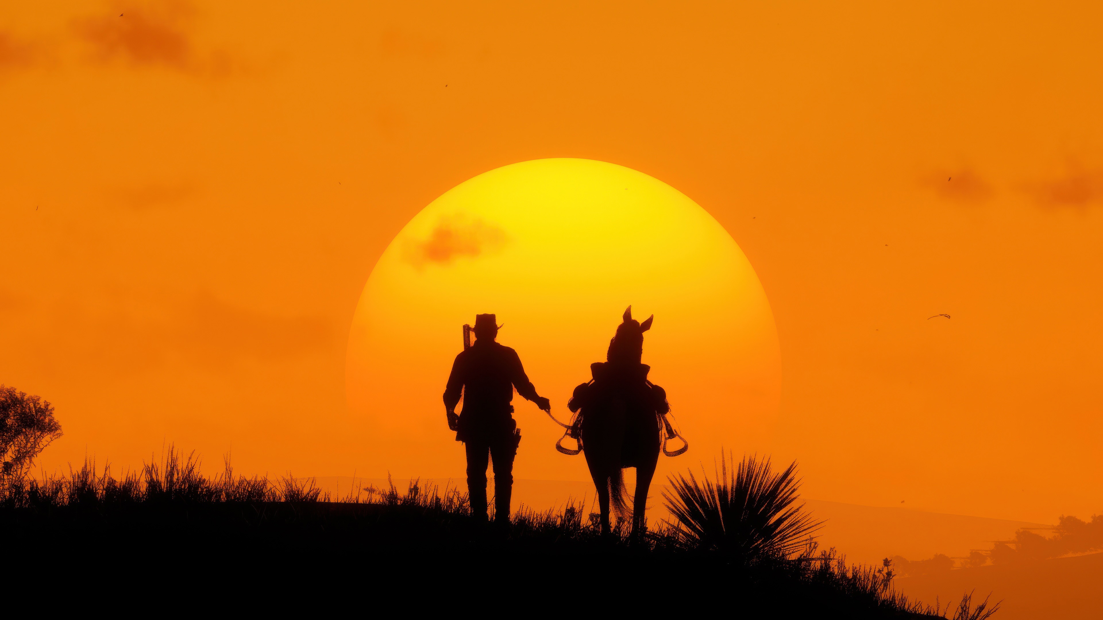 Red Dead Redemption 2 silhouette of man and horse at sunset HD Wallpaper