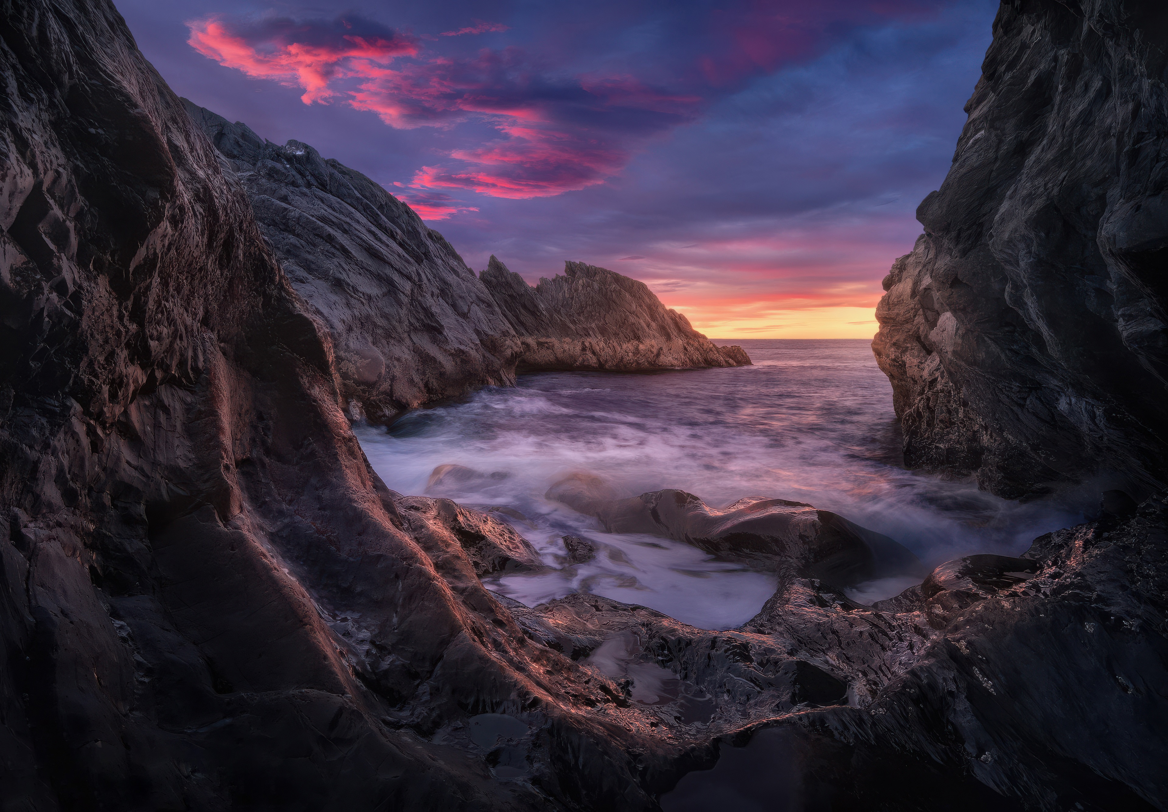 Rocky coastline at sunset with colorful clouds HD Wallpaper