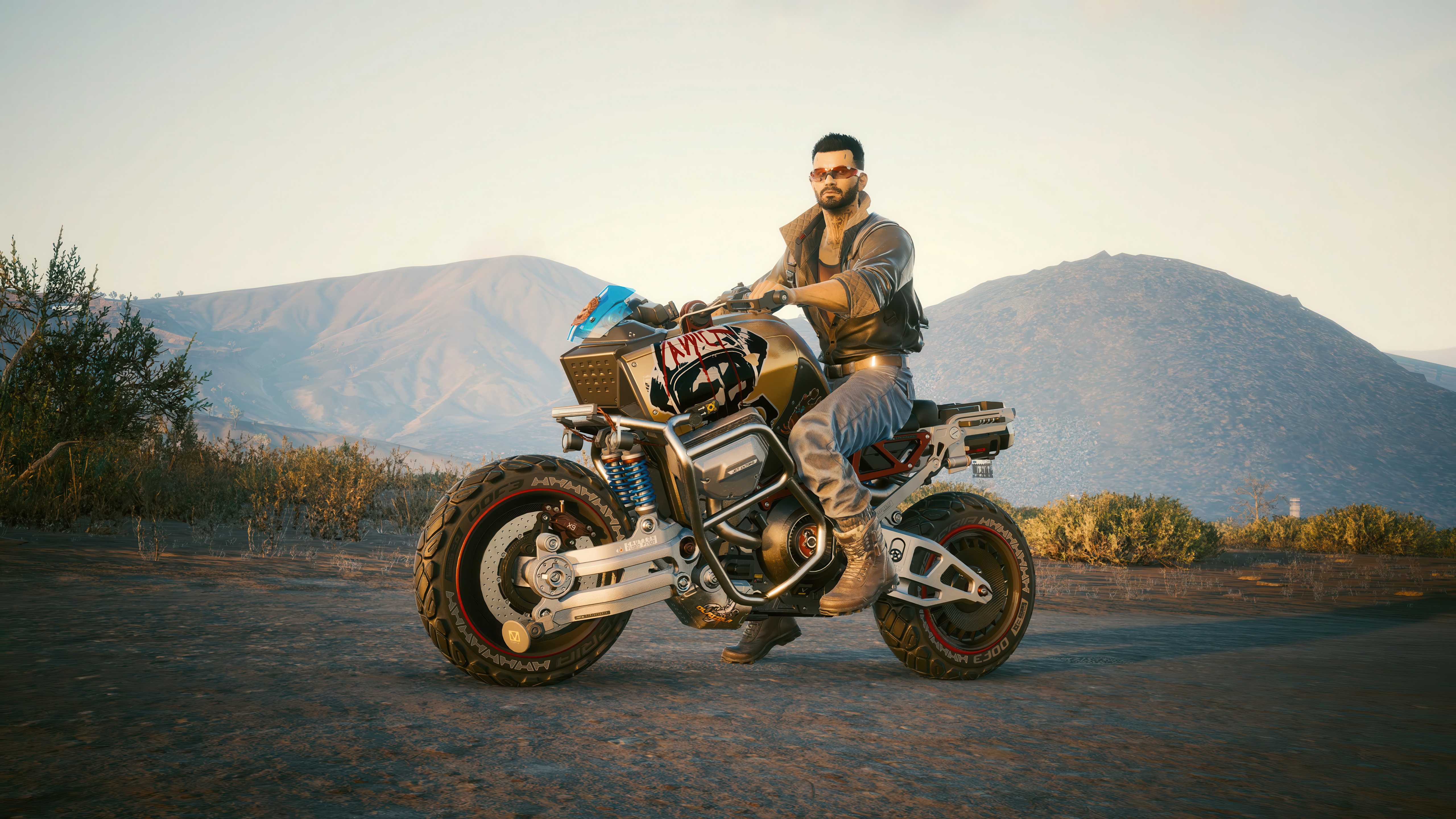 Man on a motorcycle in a desert landscape HD Wallpaper