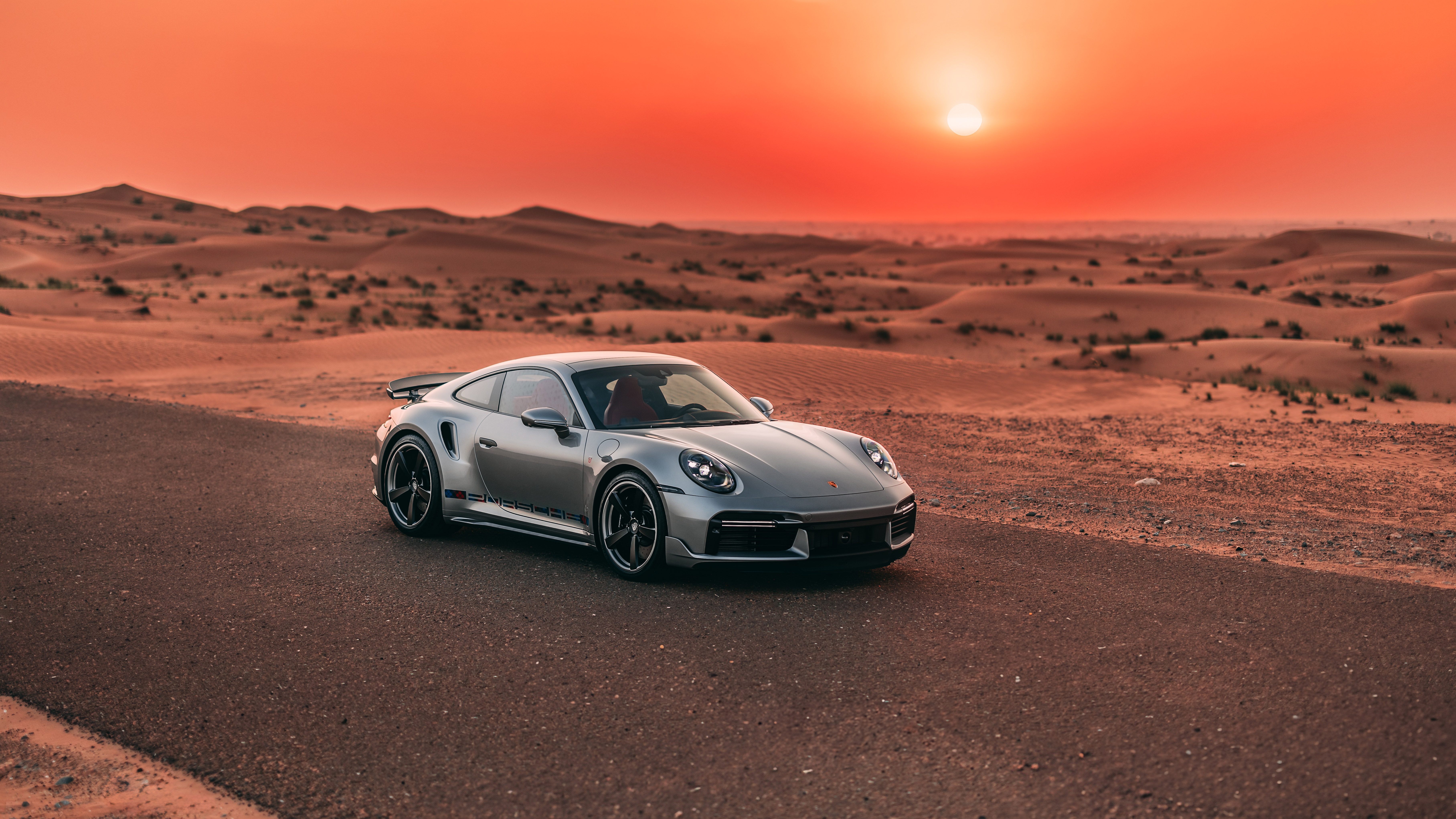Porsche 911 Turbo in a desert landscape at sunset HD Wallpaper