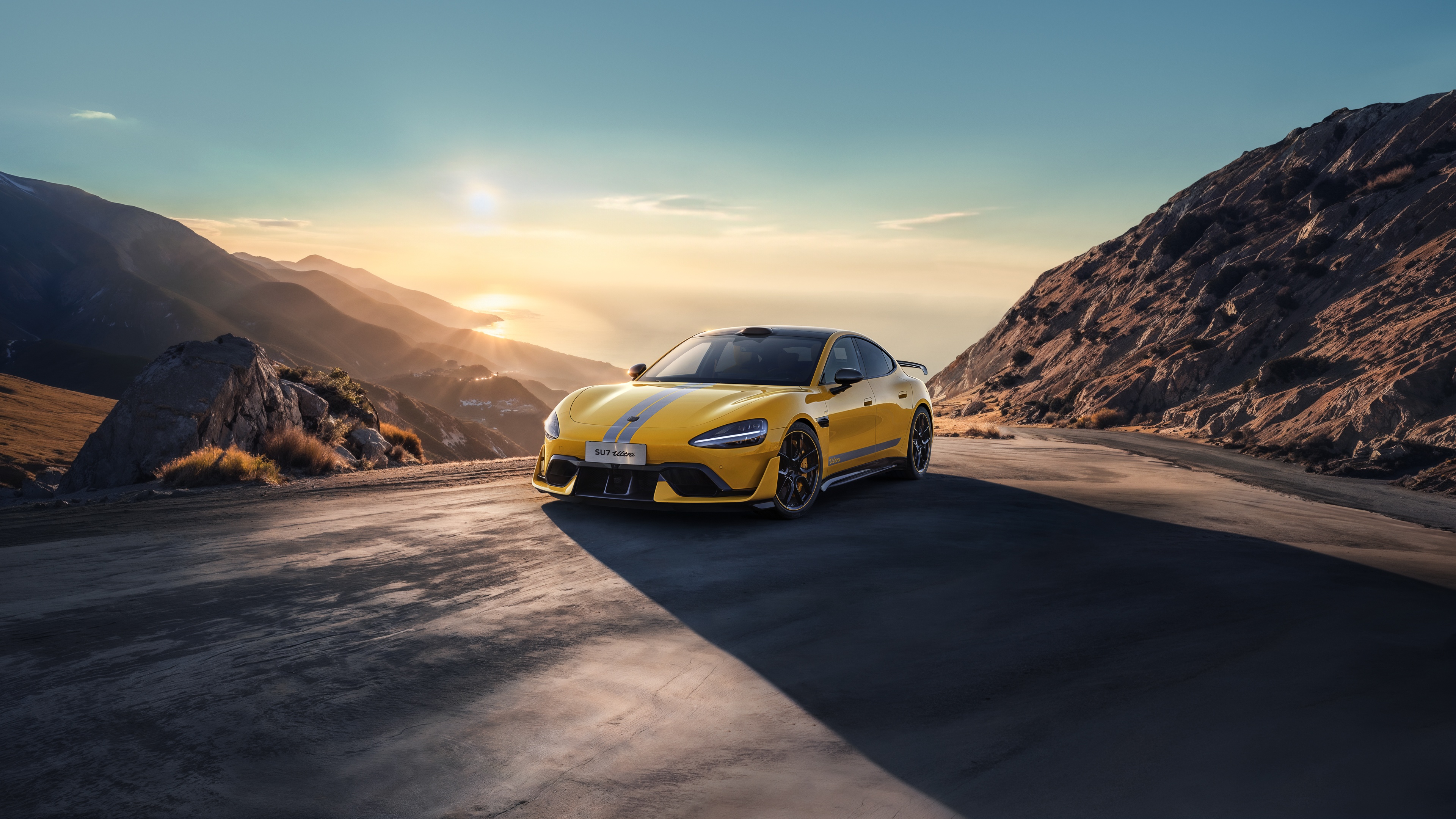 Yellow Xiaomi SU7 Ultra on a mountain road HD Wallpaper
