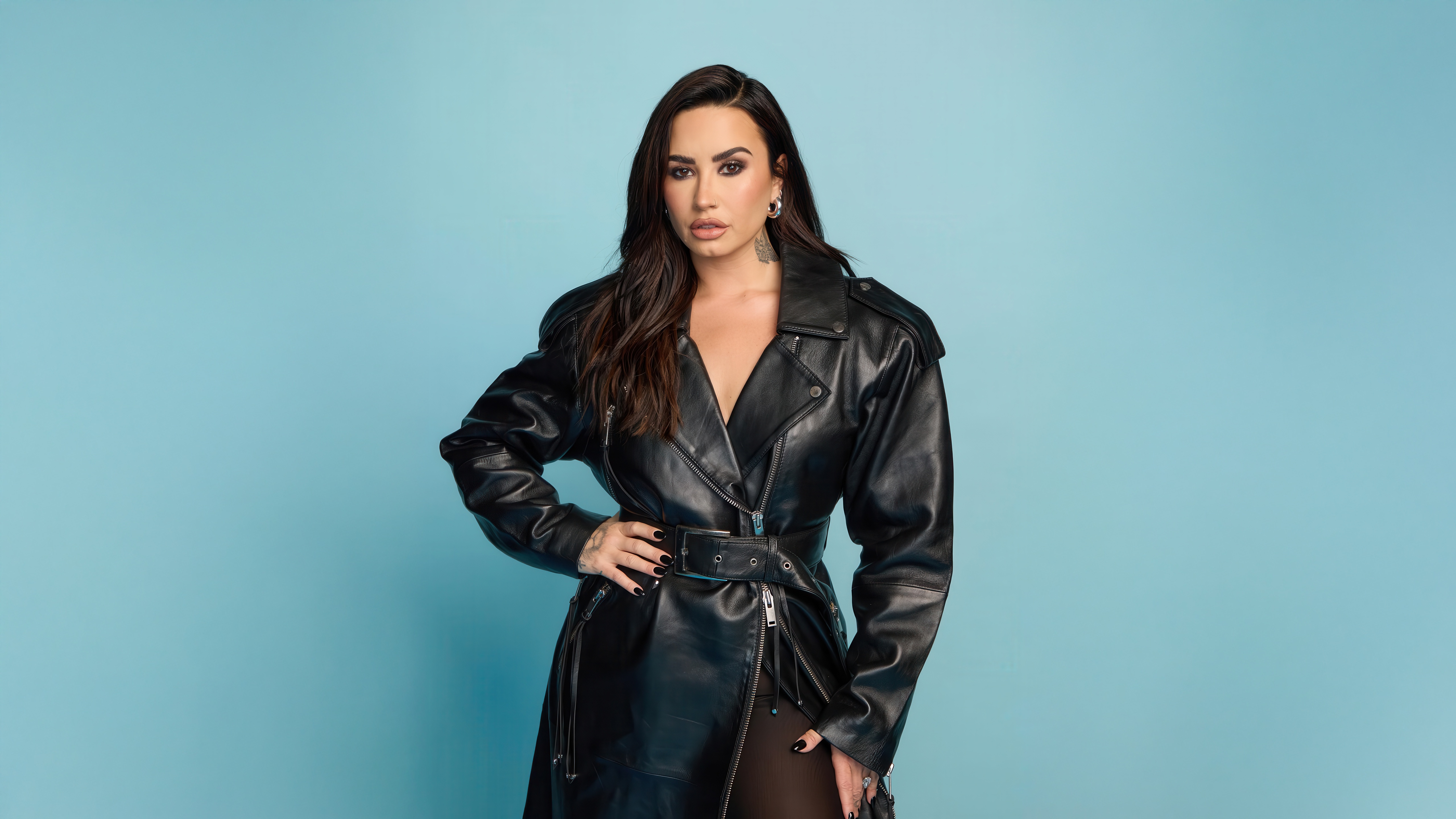 Demi Lovato in a black leather trench coat HD Wallpaper