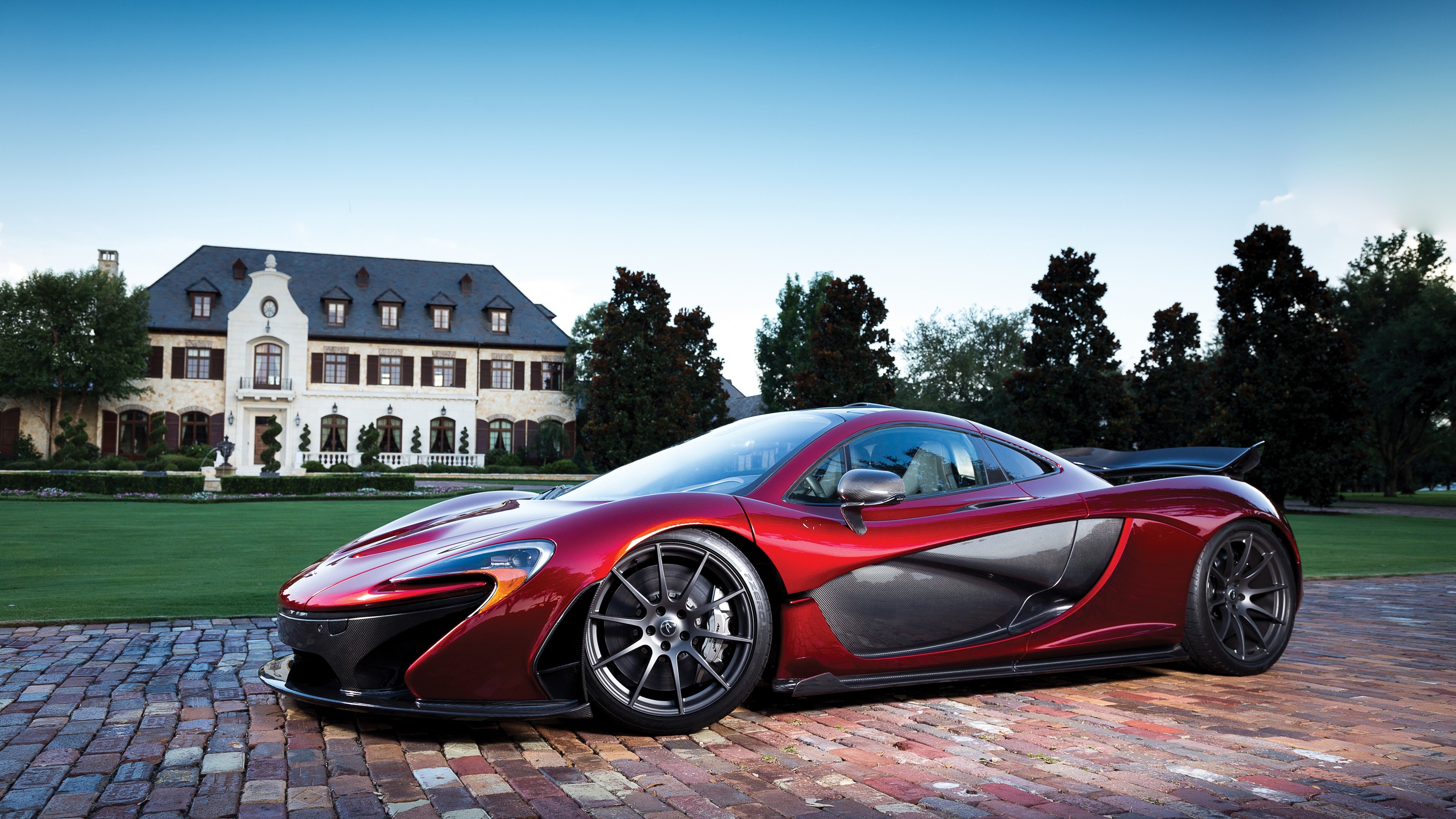Red McLaren P1 parked in front of a mansion HD Wallpaper