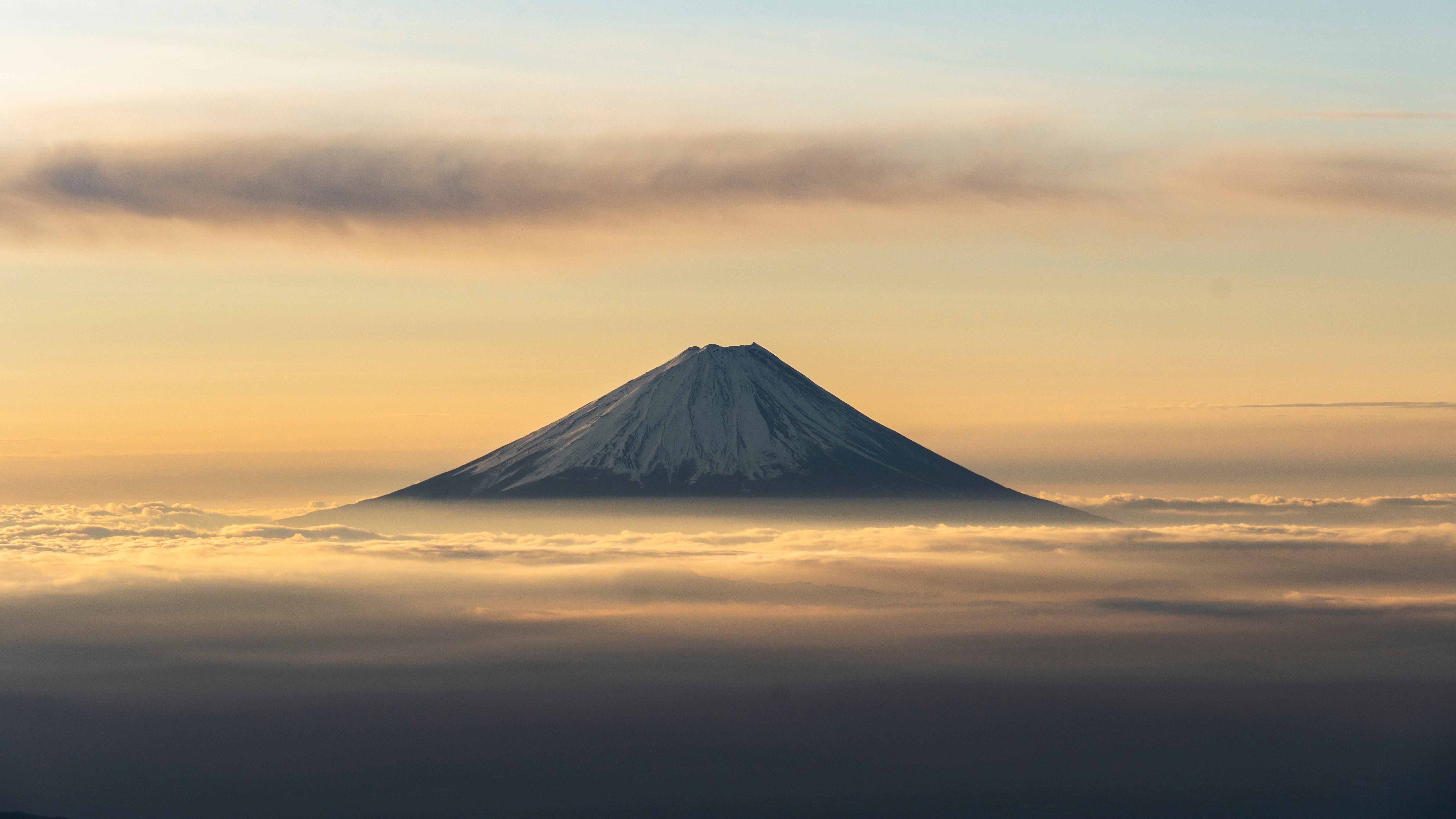 Mount Fuji above the clouds at sunrise HD Wallpaper