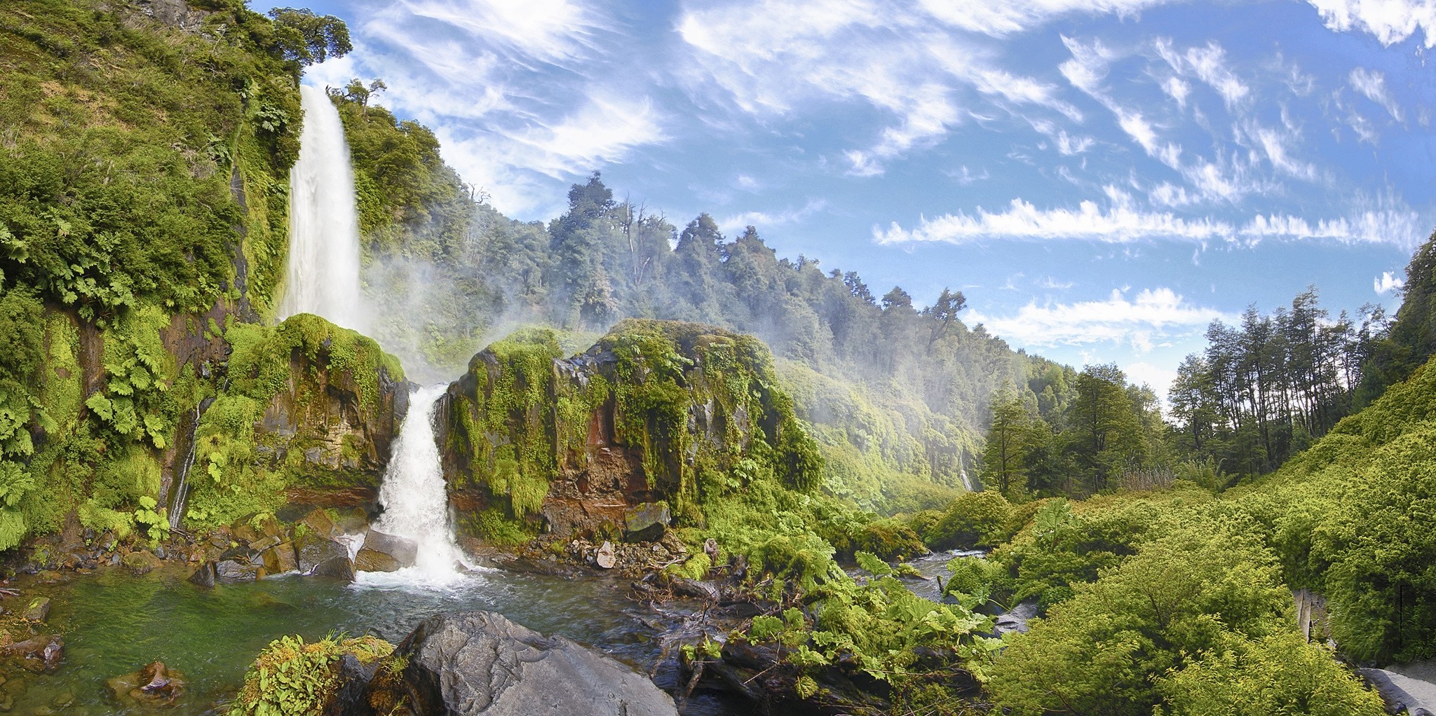 Waterfall in a lush green forest with clouds HD Wallpaper