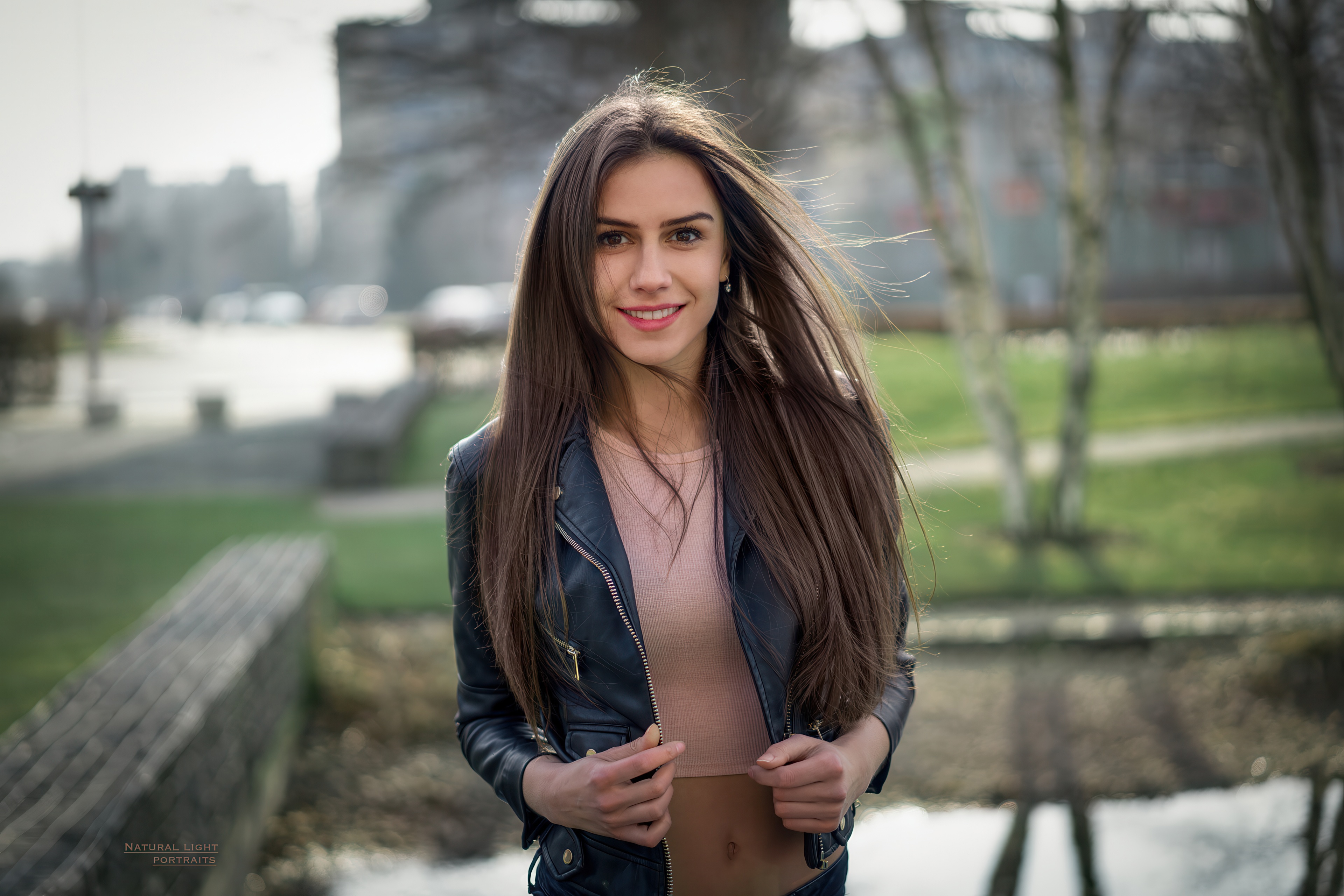 Girl in leather jacket smiling outdoors HD Wallpaper
