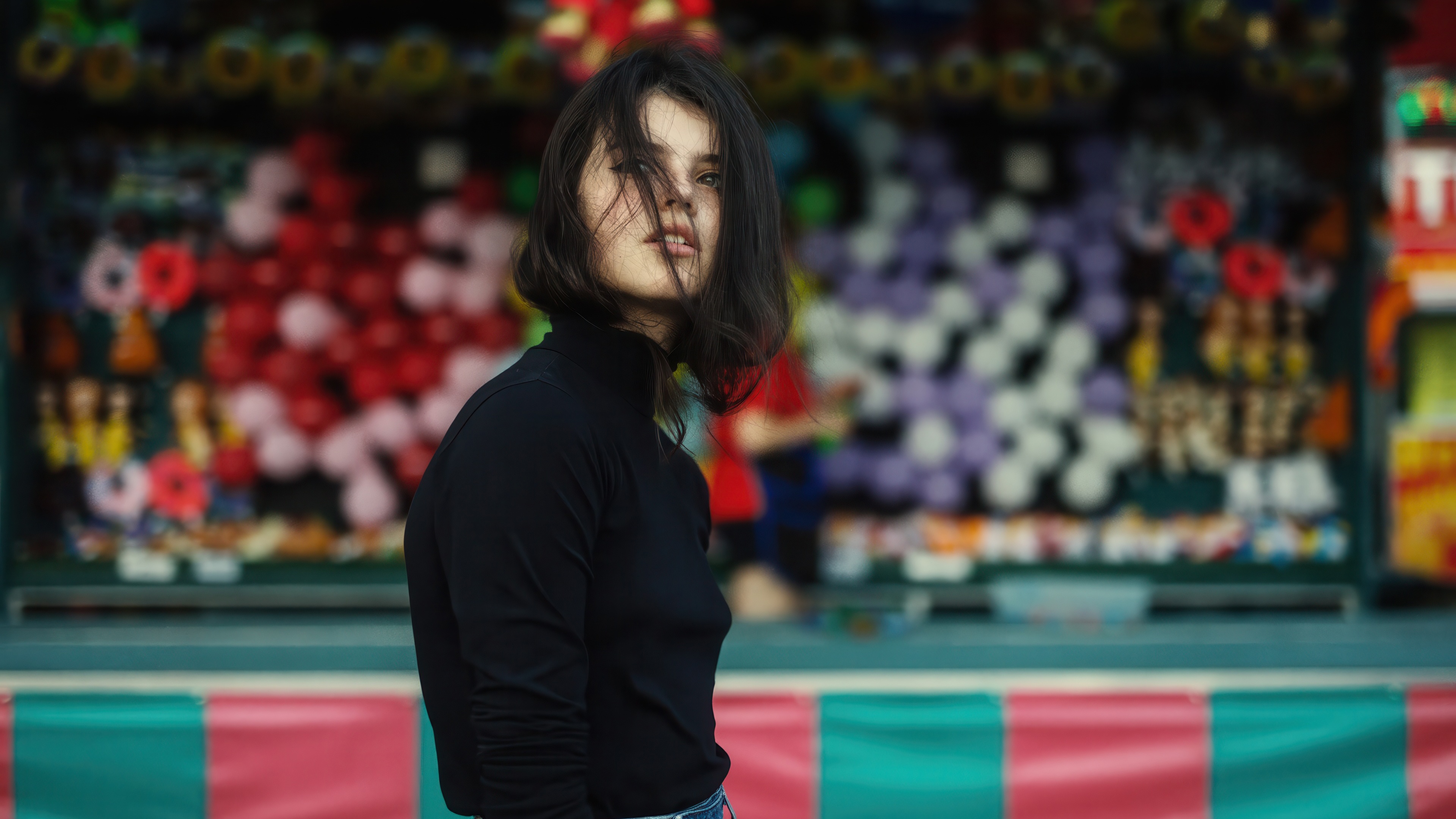 Raluca Vlad with hair on face at amusement park HD Wallpaper