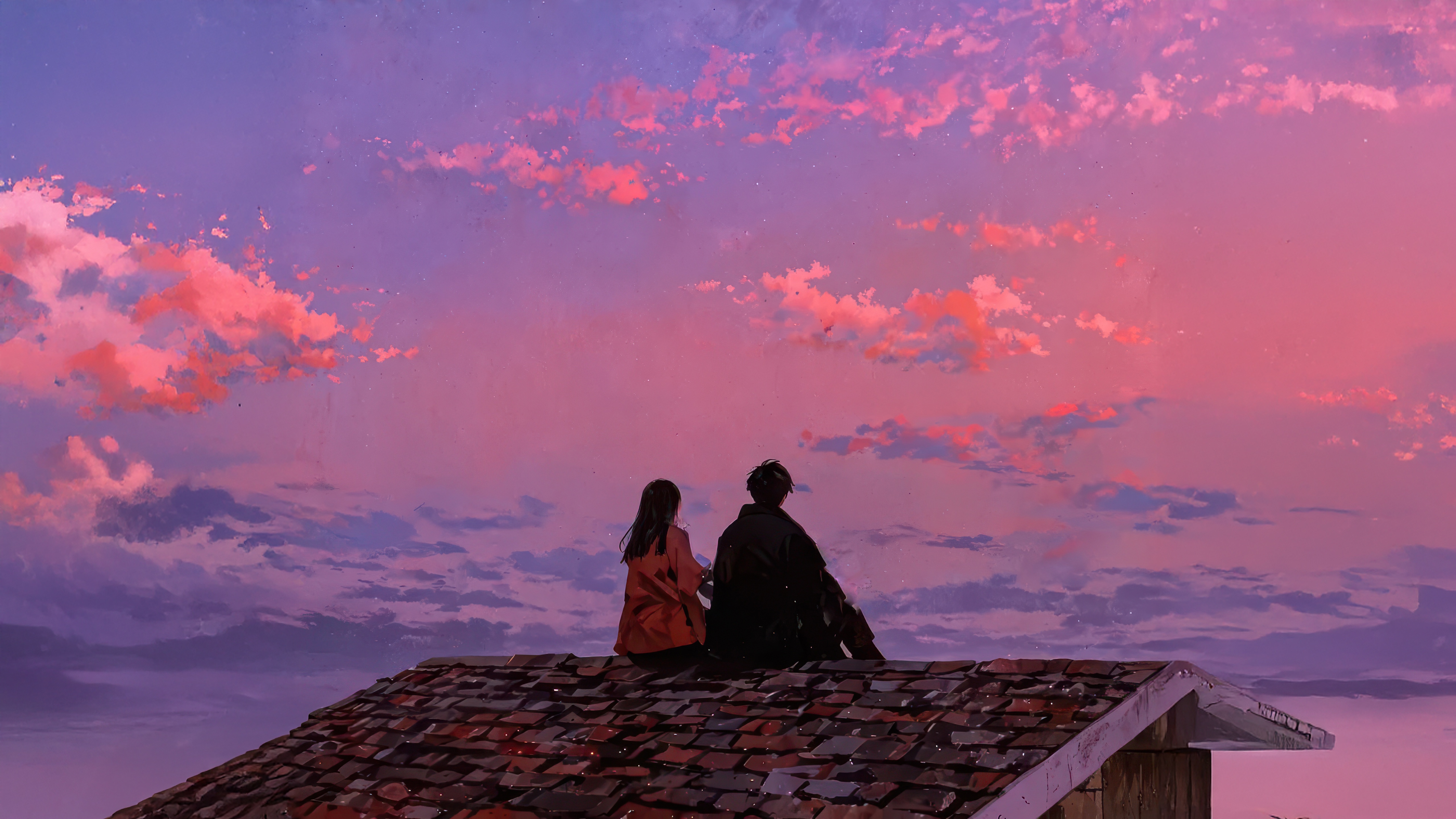 Couple sitting on a rooftop at sunset HD Wallpaper