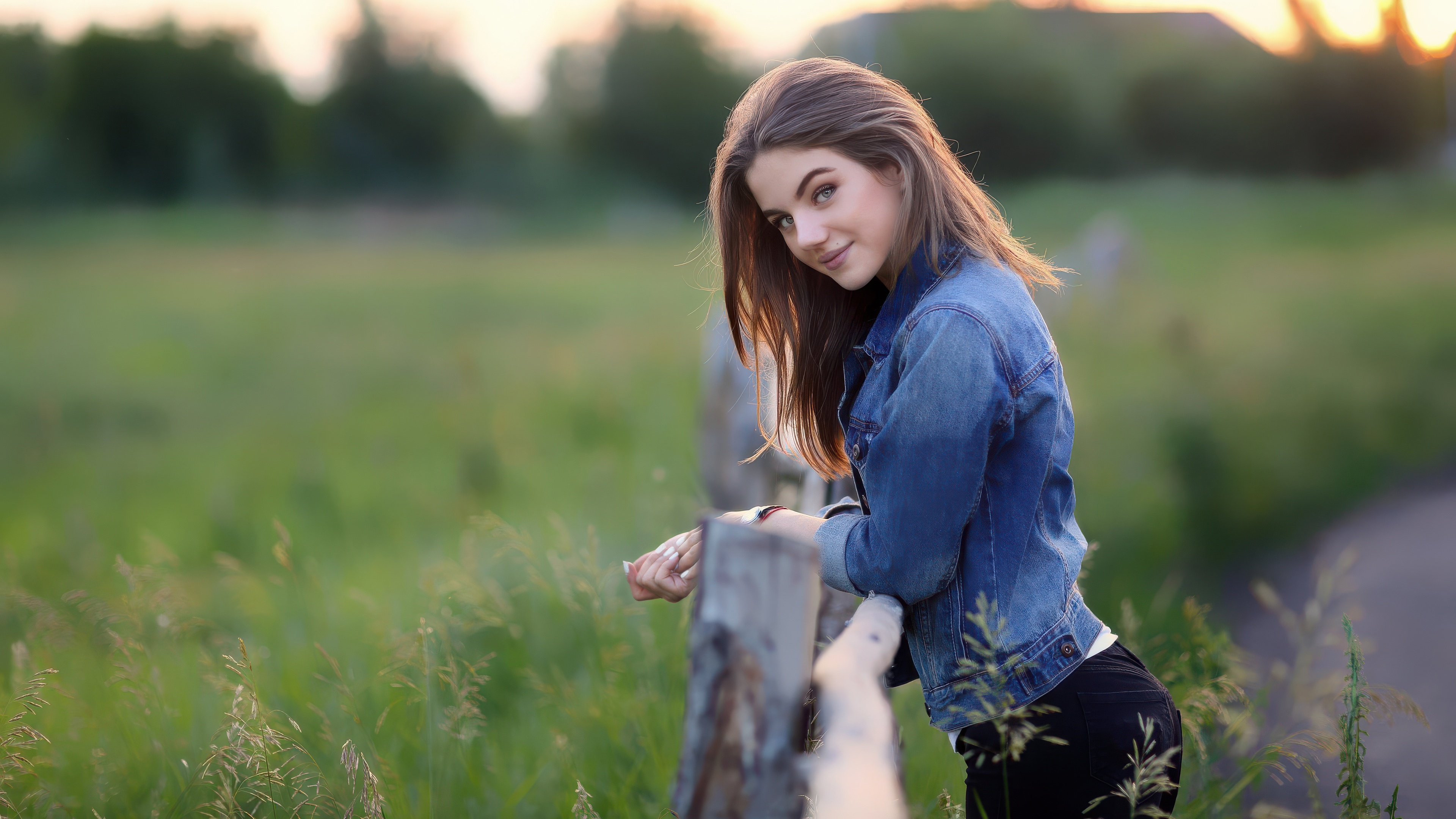 Girl in denim jacket at sunset in fields HD Wallpaper
