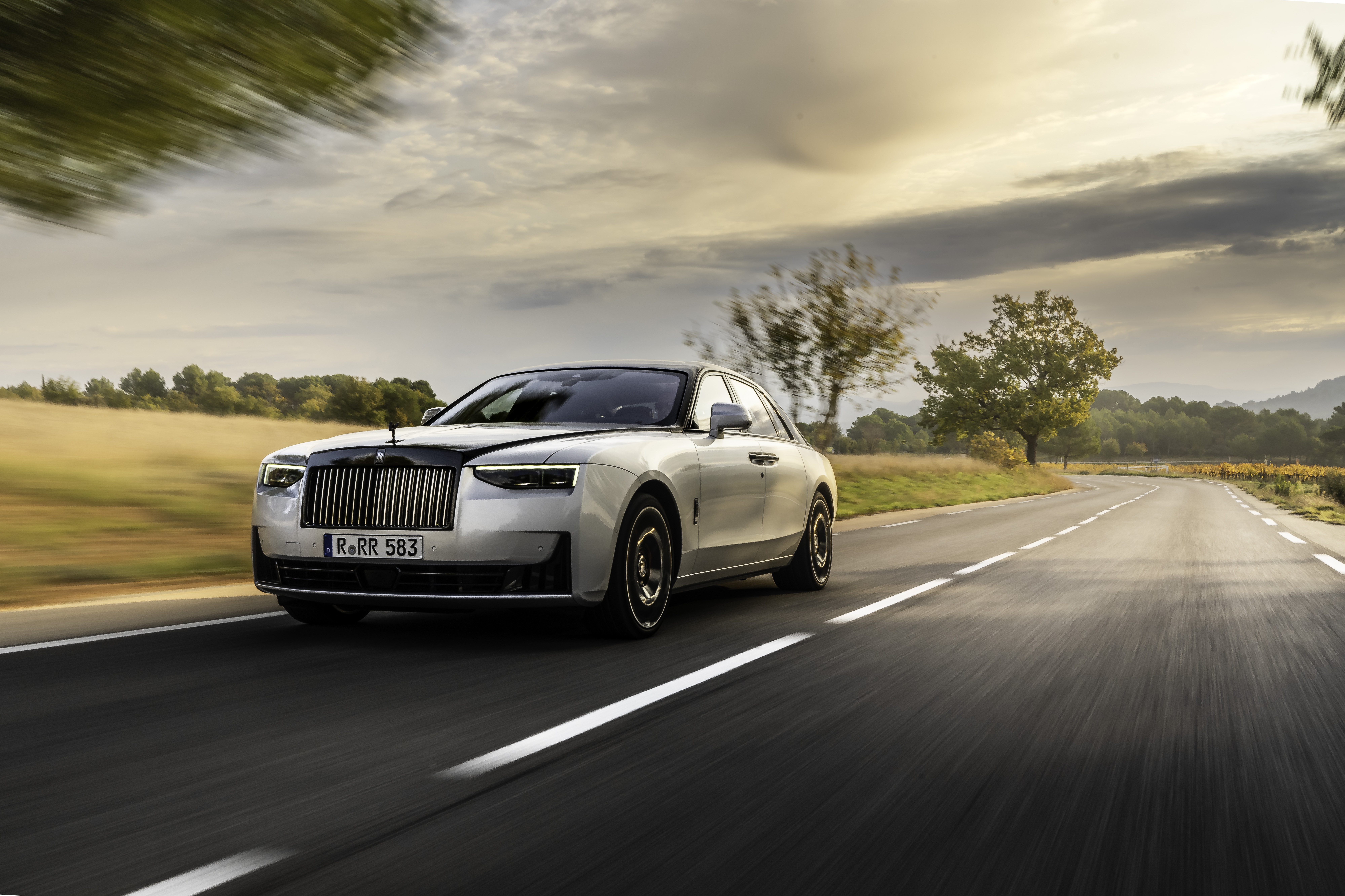 Rolls Royce Black Badge Ghost Aesthete driving on road HD Wallpaper
