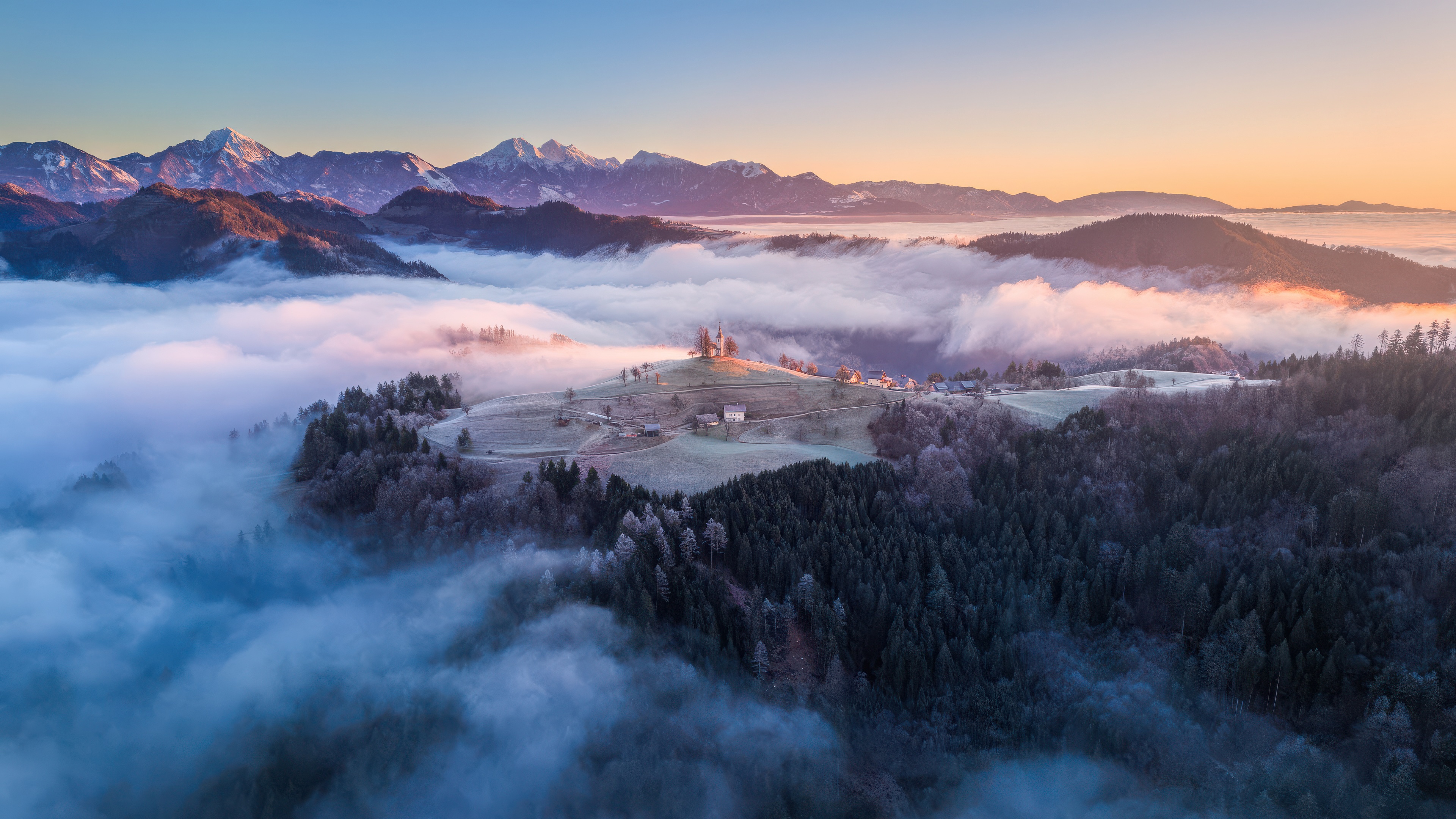 Church on a hill above fog and mountains HD Wallpaper